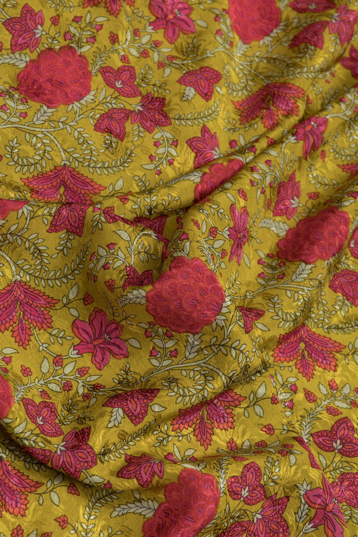 Close up of Mustard Dual Tone Mysore Crepe Saree with Printed design on the body and Zari Border.  displaying folds