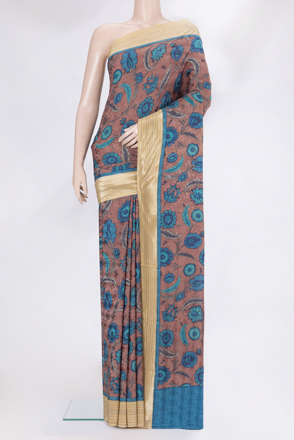 Brown Crepe Saree with Printed design on the body and Zari Border.  displayed on a mannequin