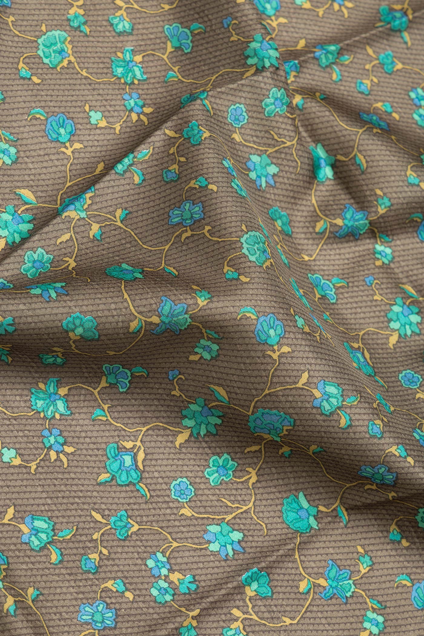 Close up of Mehandi Green Dual Tone Printed Silk Saree with Printed design on the body and Printed Border.  displaying folds