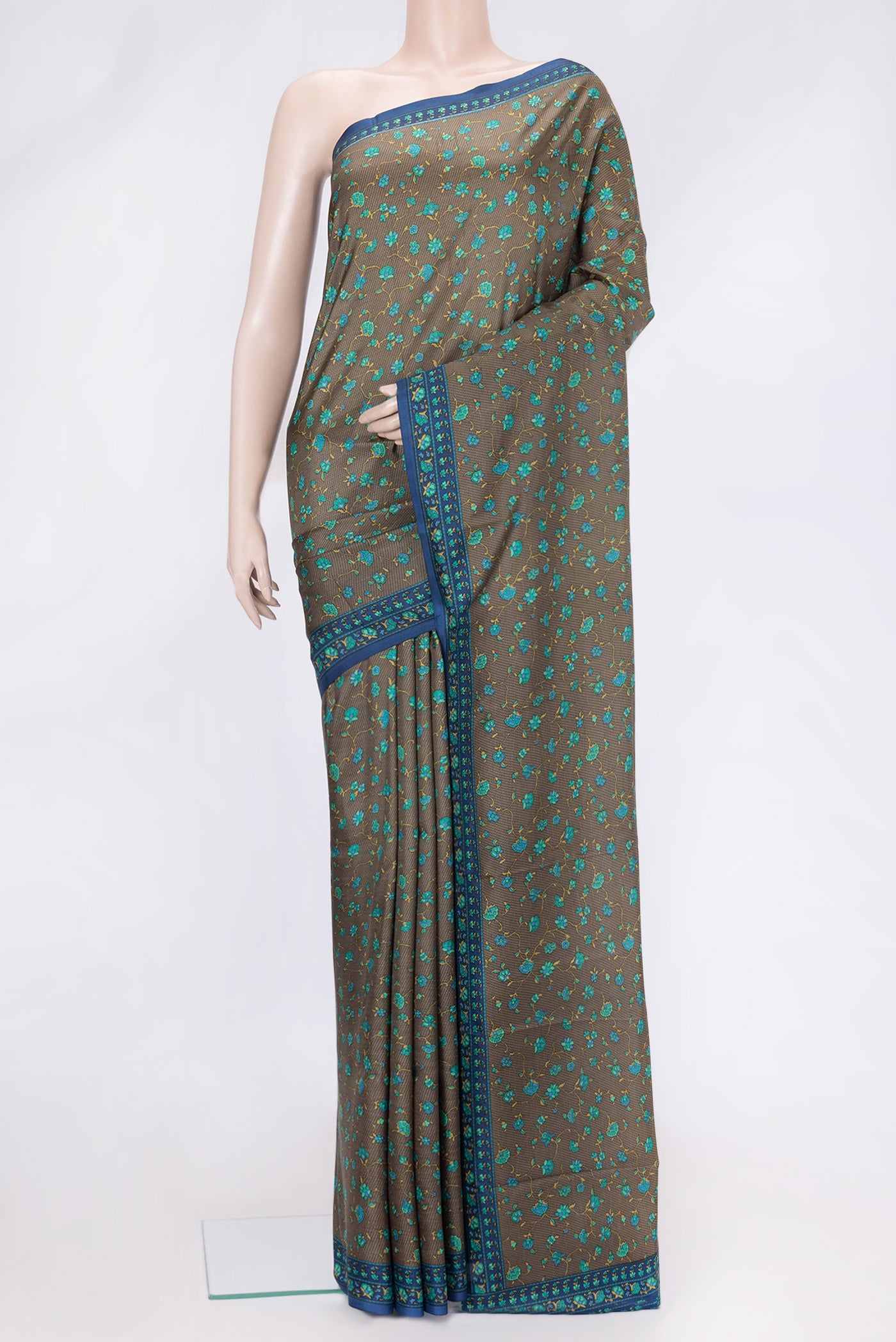 Mehandi Green Dual Tone Printed Silk Saree with Printed design on the body and Printed Border.  displayed on a mannequin