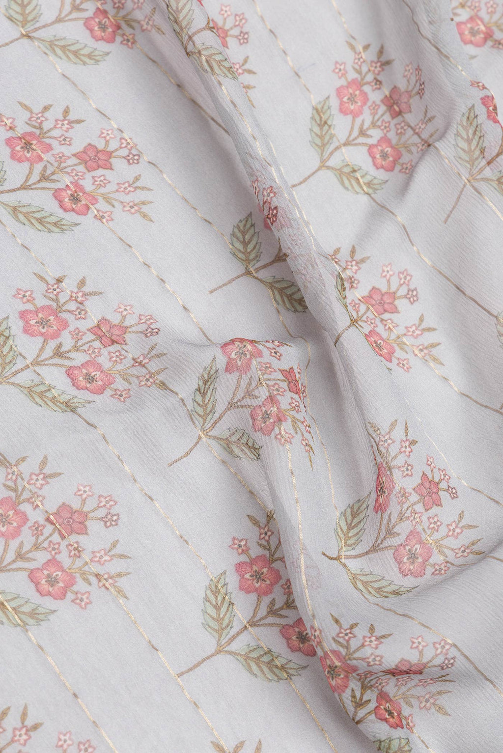 Close up of Grey Dual Tone Mysore Georgette Saree with Printed design on the body and Zari Border.  displaying folds