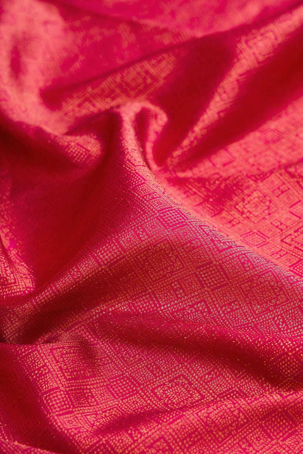 Close up of Pink Kanchipuram Silk Saree with Zari Brocade on the body and Fancy Border.  displaying folds