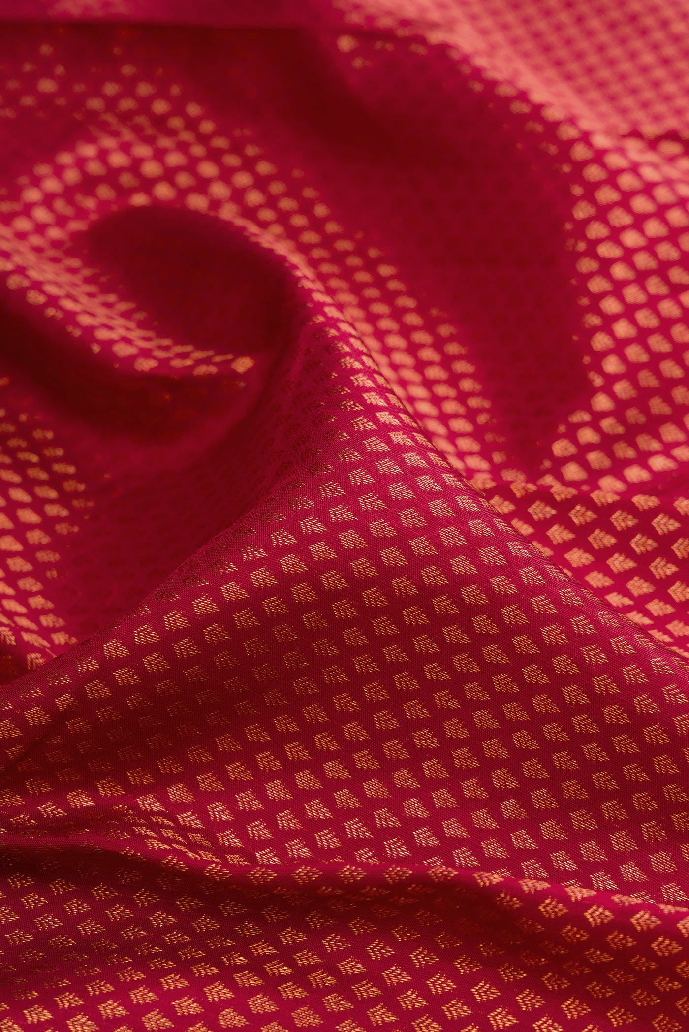Close up of Maroon Kanchipuram Silk Saree with Zari Brocade on the body and Fancy Border.  displaying folds