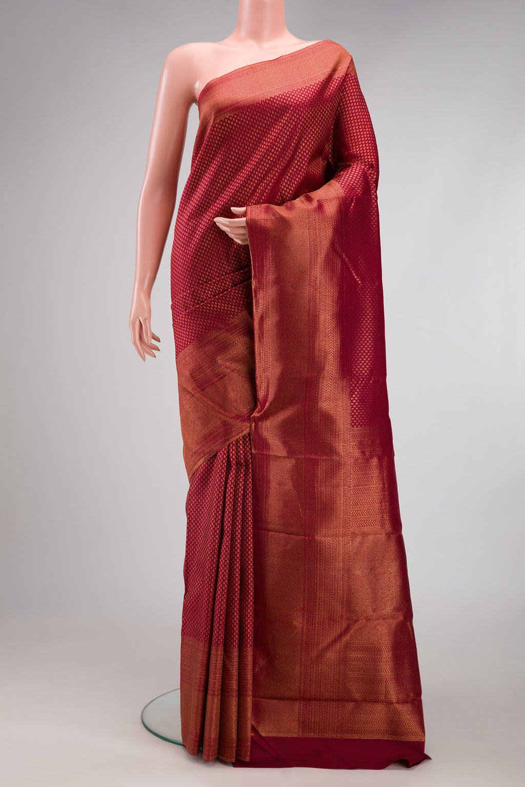 Maroon Kanchipuram Silk Saree with Zari Brocade on the body and Fancy Border.  displayed on a mannequin