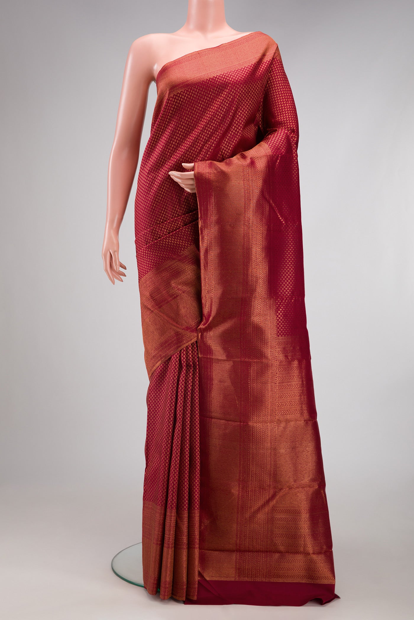 Maroon Kanchipuram Silk Saree with Zari Brocade on the body and Fancy Border.  displayed on a mannequin