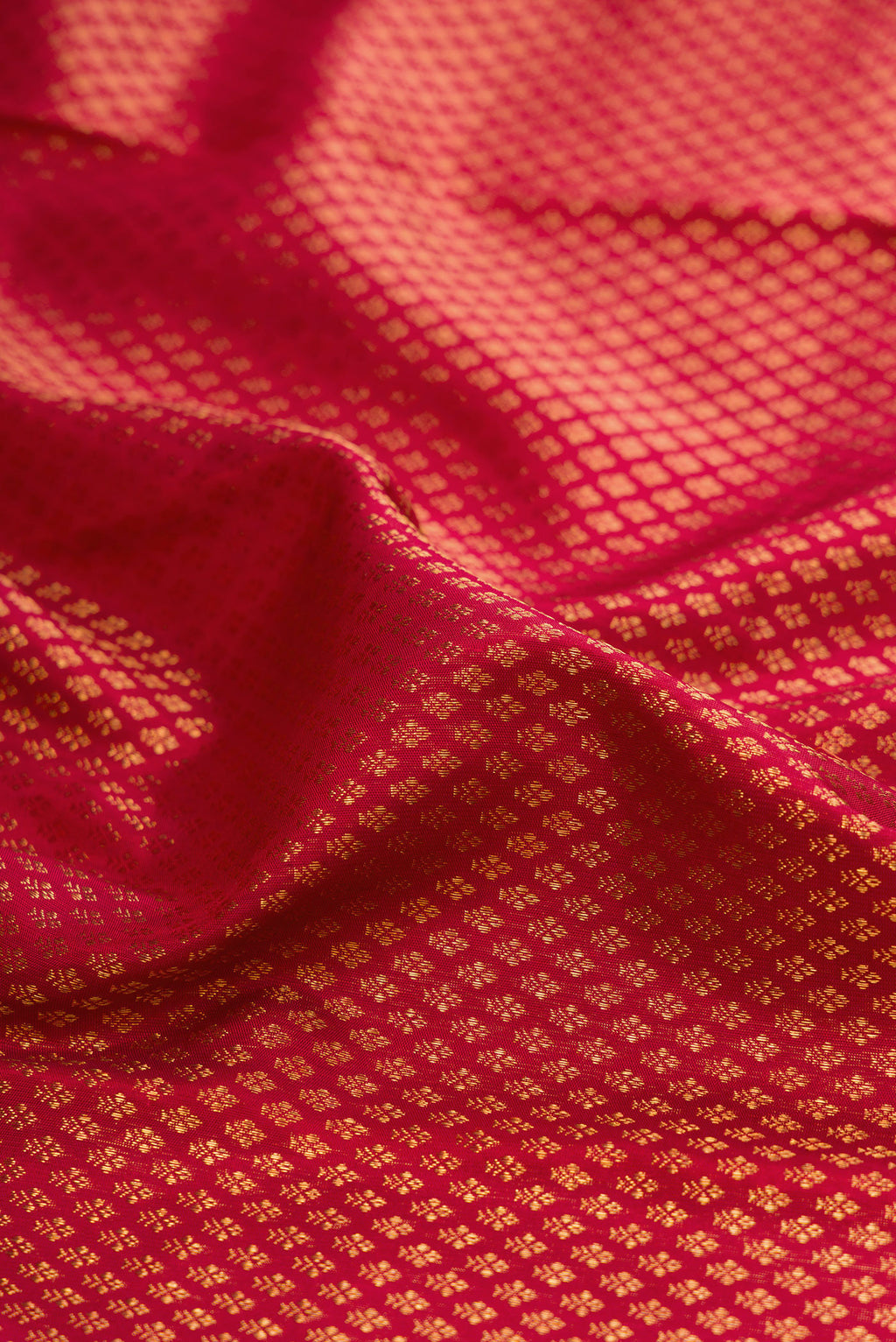 Close up of Red Kanchipuram Silk Saree with Zari Brocade on the body and Fancy Border.  displaying folds