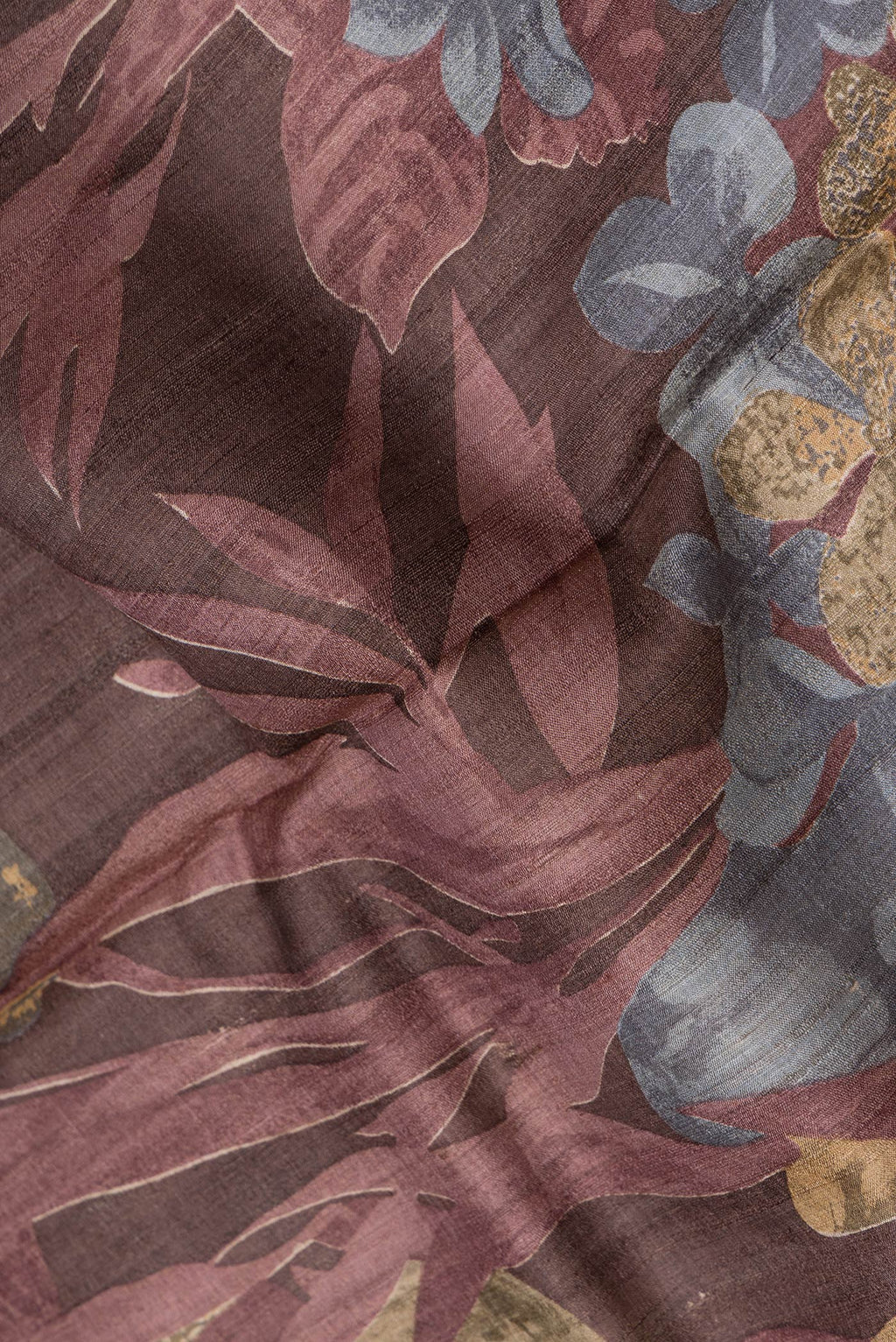 Close up of Maroon Dual Tone Tussar Silk Saree with Printed design on the body and Zari Border.  displaying folds