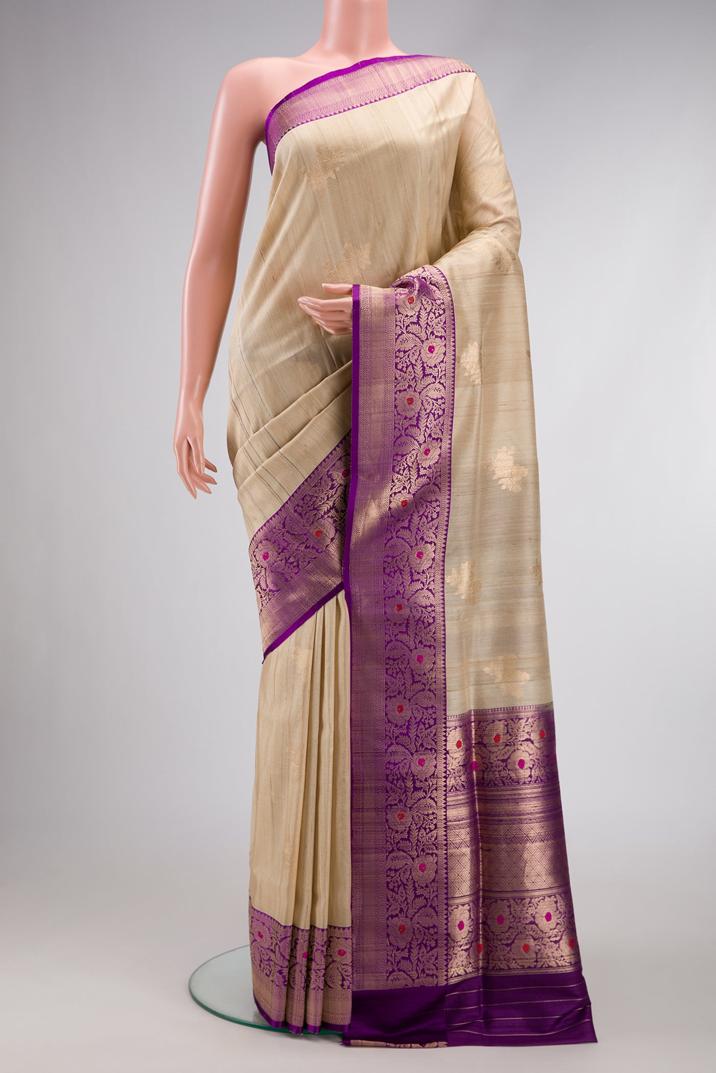 Beige Dual Tone Tussar Silk Saree with Zari Butta on the body and Zari And Thread Border.  displayed on a mannequin