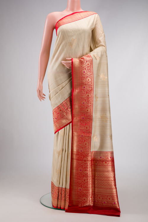 Beige Dual Tone Tussar Silk Saree with Zari Butta on the body and Zari And Thread Border.  displayed on a mannequin