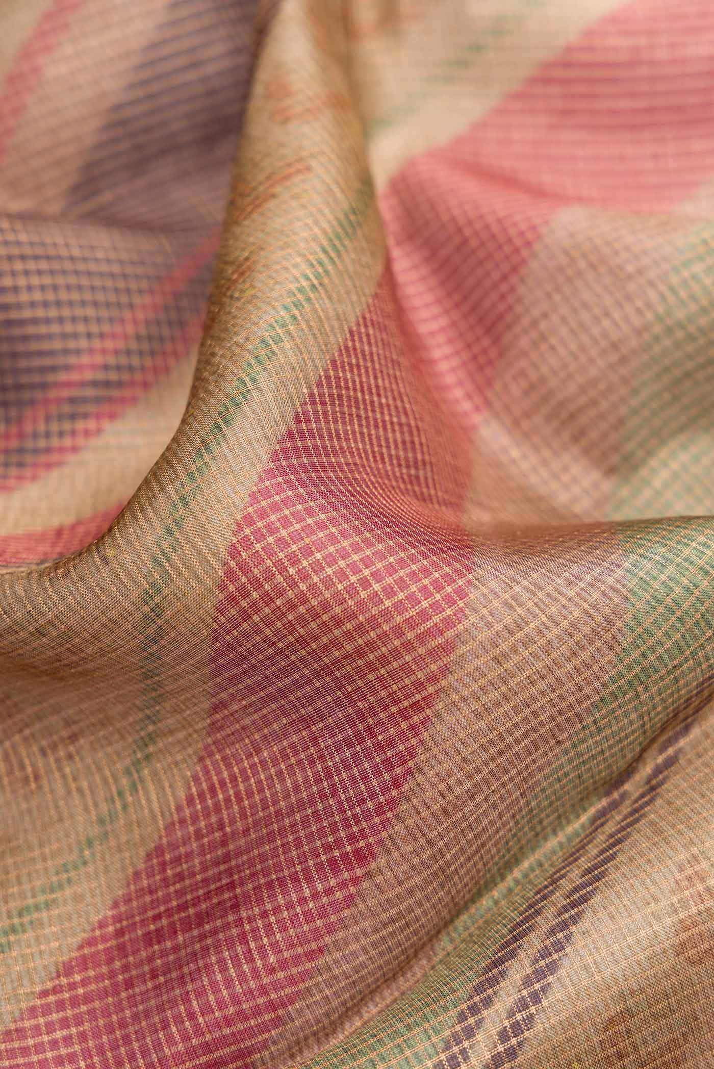Close up of Brown Dual Tone Tussar Silk Saree with Checked design on the body and Zari Border.  displaying folds