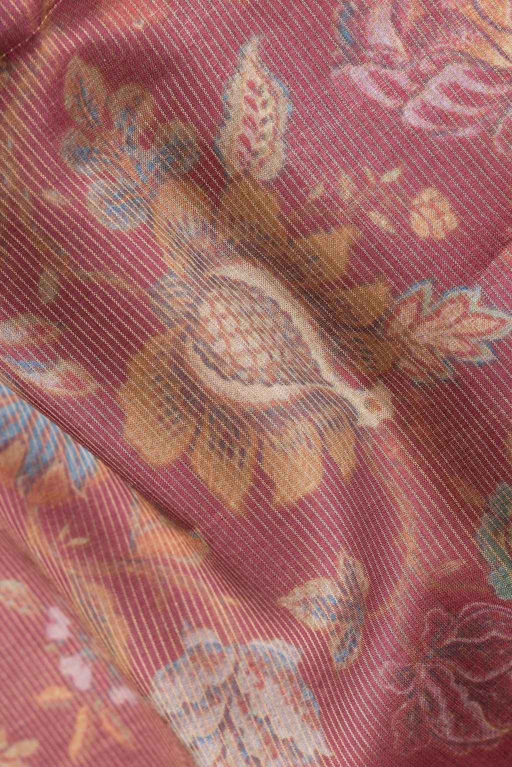 Close up of Peach Dual Tone Tussar Silk Saree with Printed design on the body and Zari Border.  displaying folds