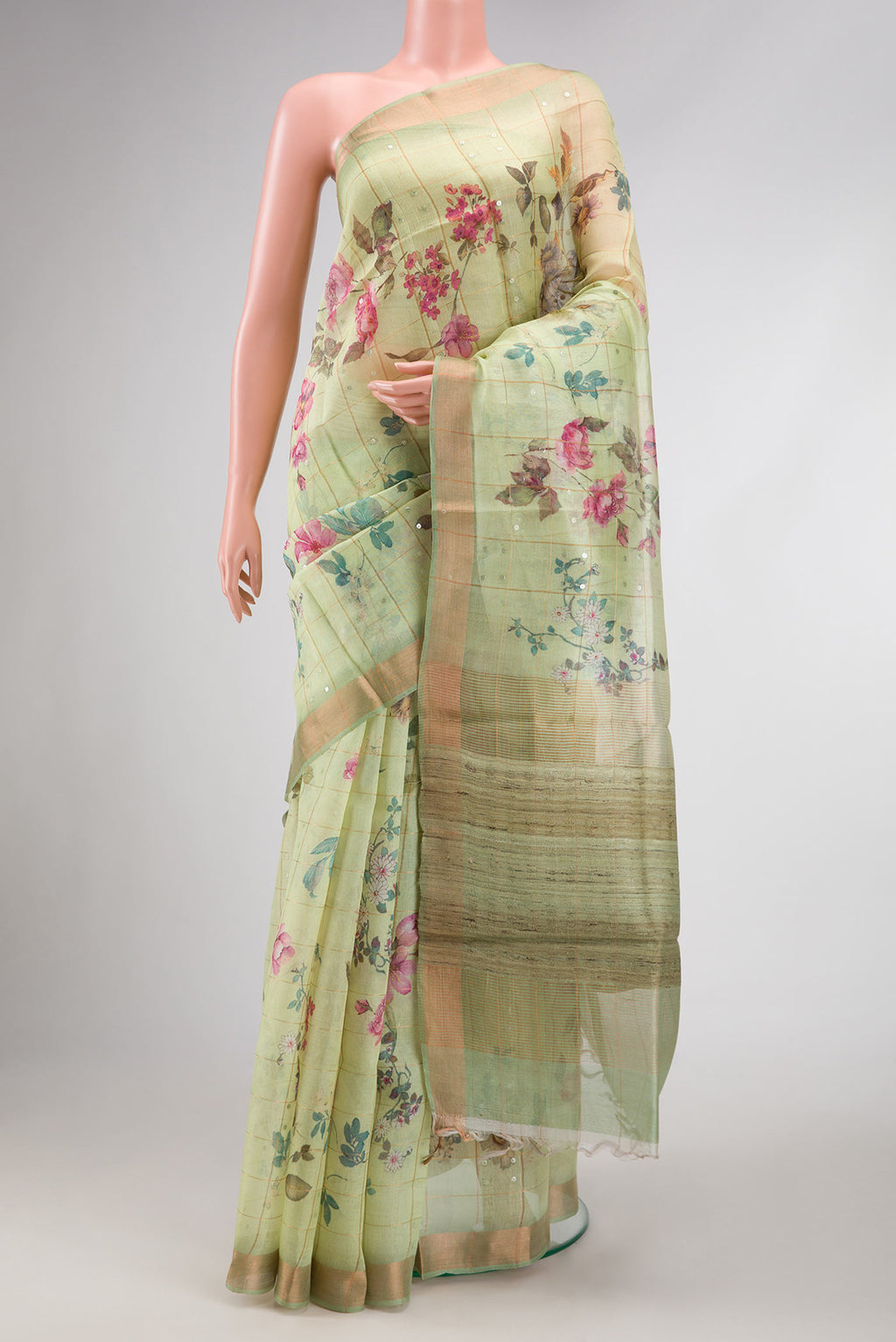 Pista Green Dual Tone Tussar Silk Saree with Zari Butta on the body and Zari Border.  displayed on a mannequin