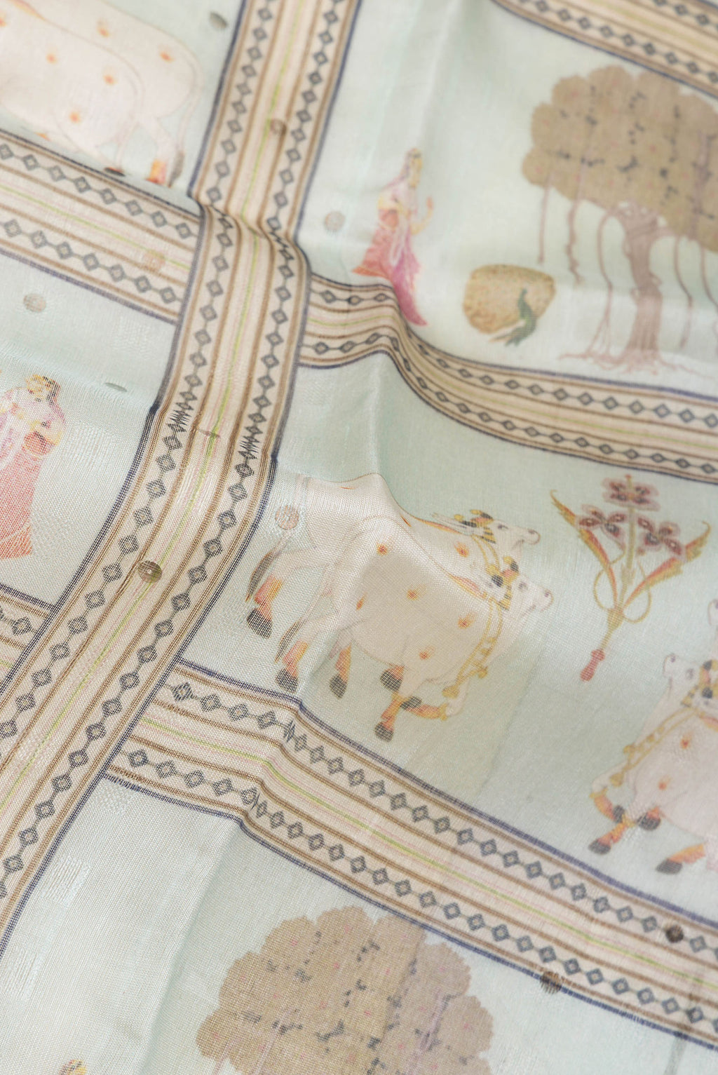 Close up of Pista Green Dual Tone Tussar Silk Saree with Printed design on the body and Zari Border.  displaying folds
