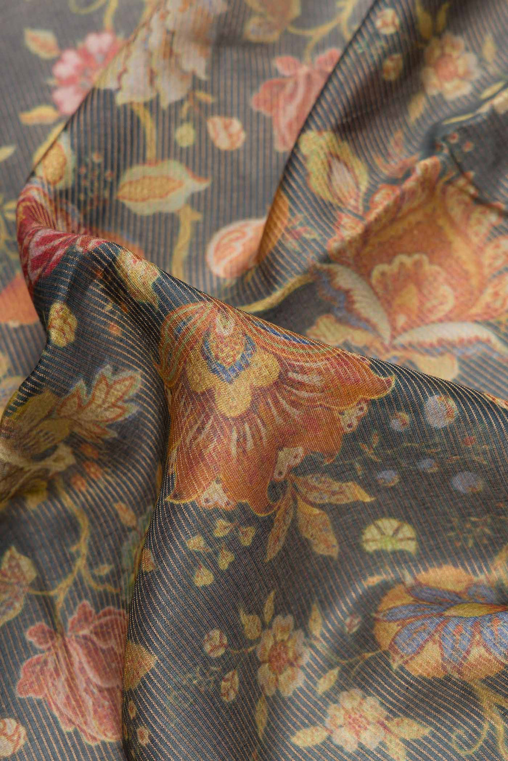 Close up of Navy Blue Dual Tone Tussar Silk Saree with Printed design on the body and Zari Border.  displaying folds