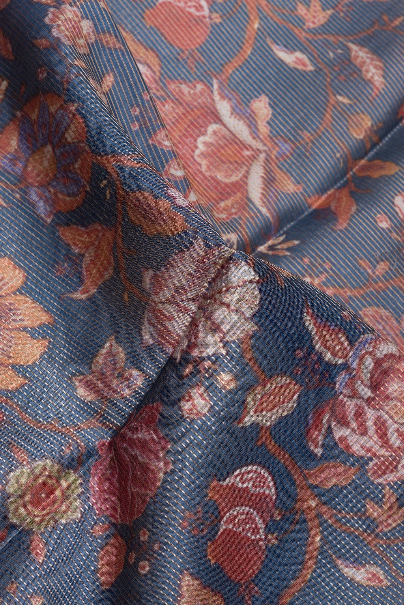 Close up of Navy Blue Dual Tone Tussar Silk Saree with Printed design on the body and Zari Border.  displaying folds