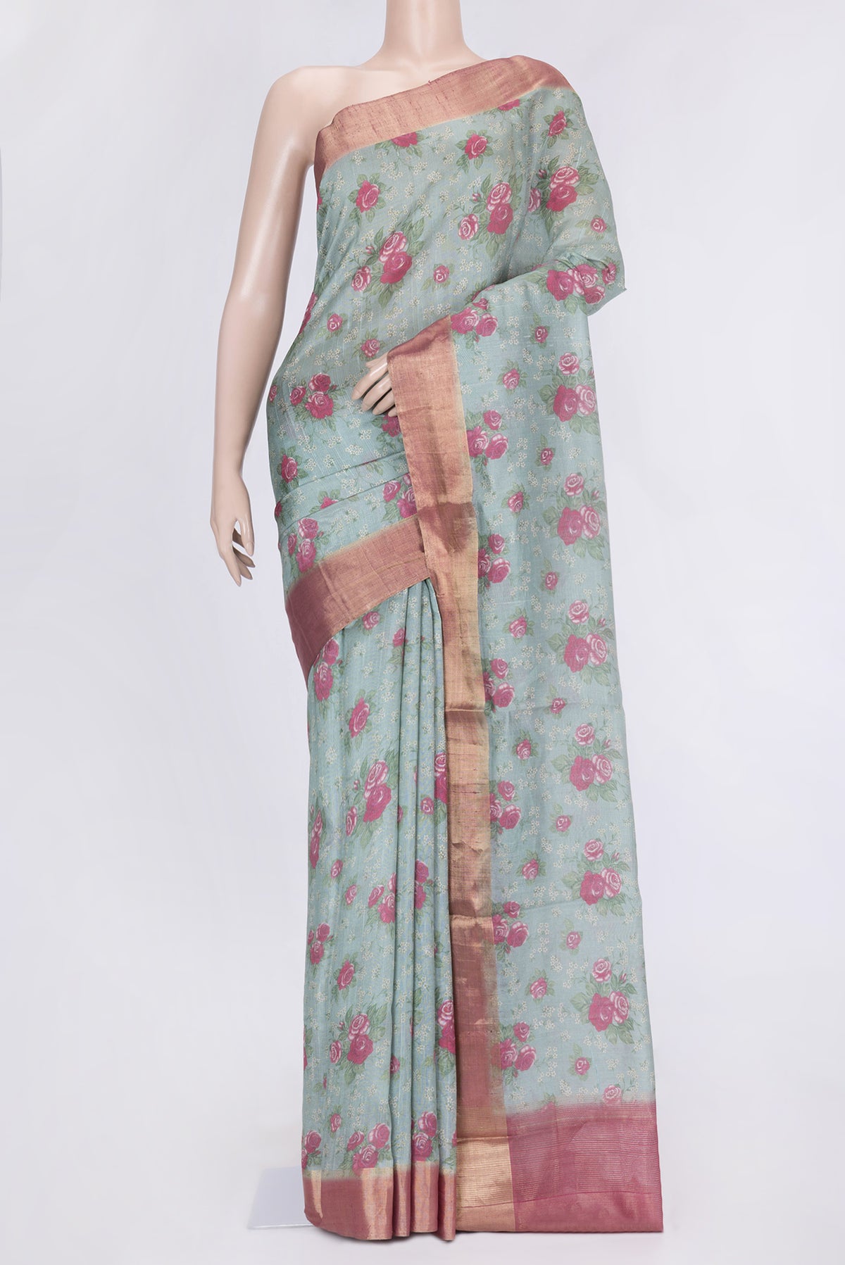 Green Dual Tone Tussar Silk Saree with Printed design on the body and Zari Border.  displayed on a mannequin