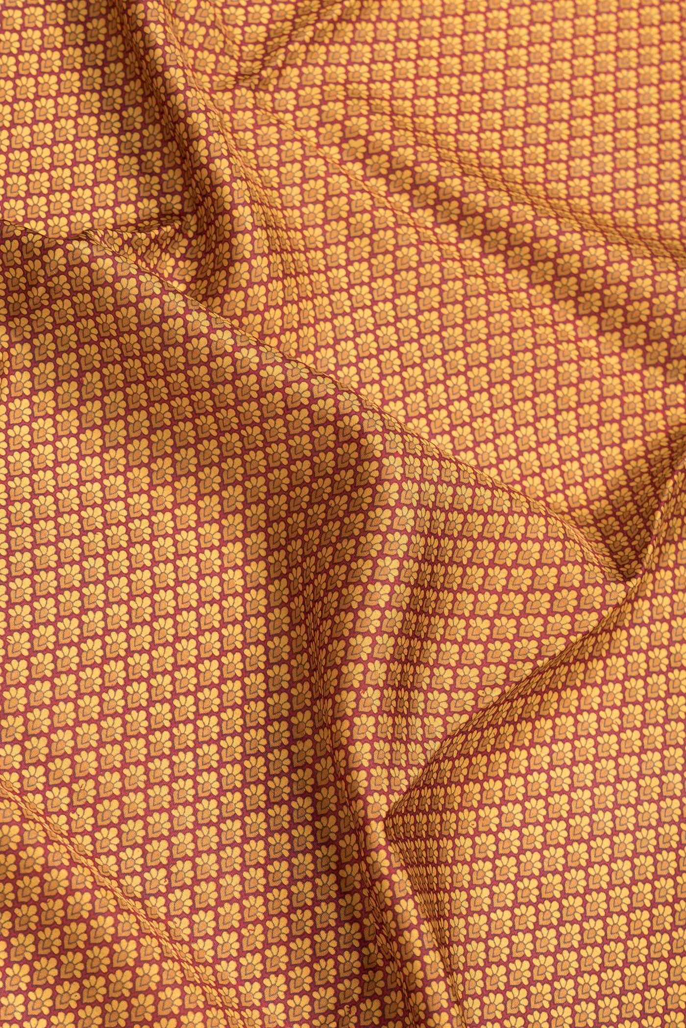 Close up of Maroon Dual Tone Printed Silk Saree with Printed design on the body and Printed Border.  displaying folds