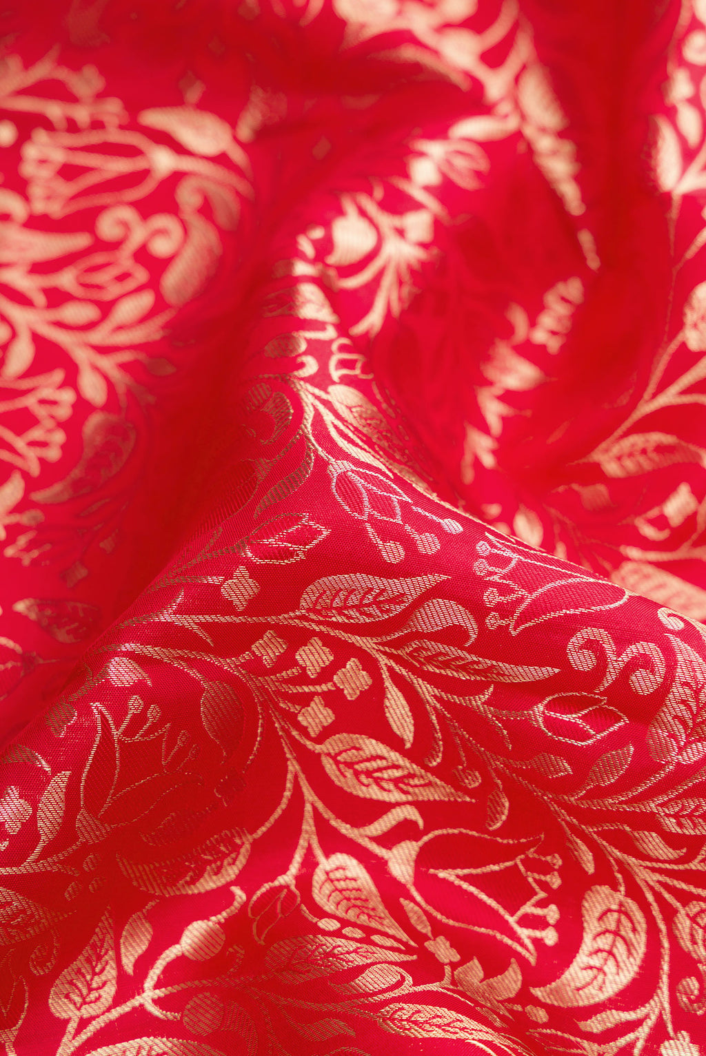 Close up of Red Dual Tone Kanchipuram Silk Saree with Zari Brocade on the body and Zari Border.  displaying folds