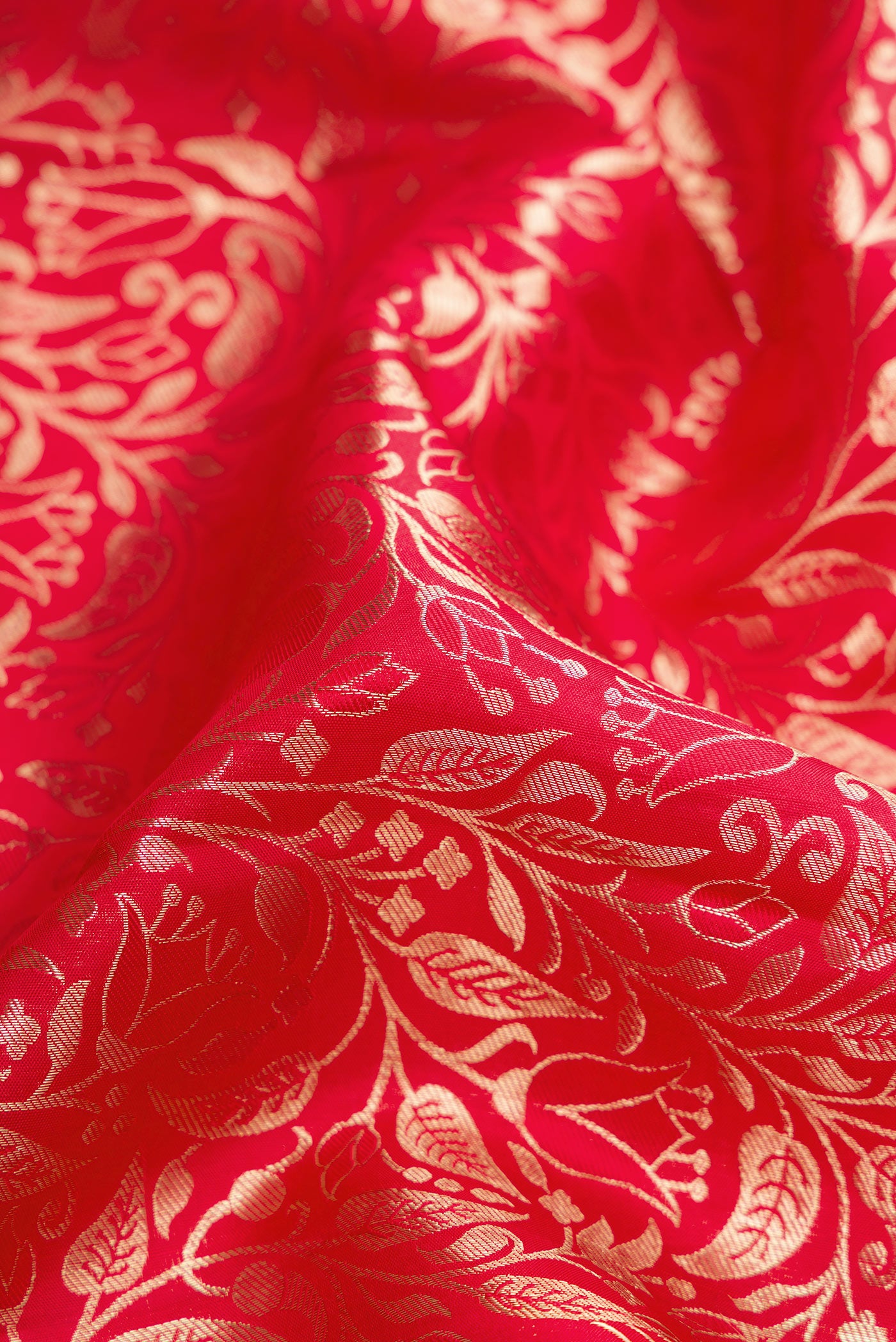Close up of Red Dual Tone Kanchipuram Silk Saree with Zari Brocade on the body and Zari Border.  displaying folds
