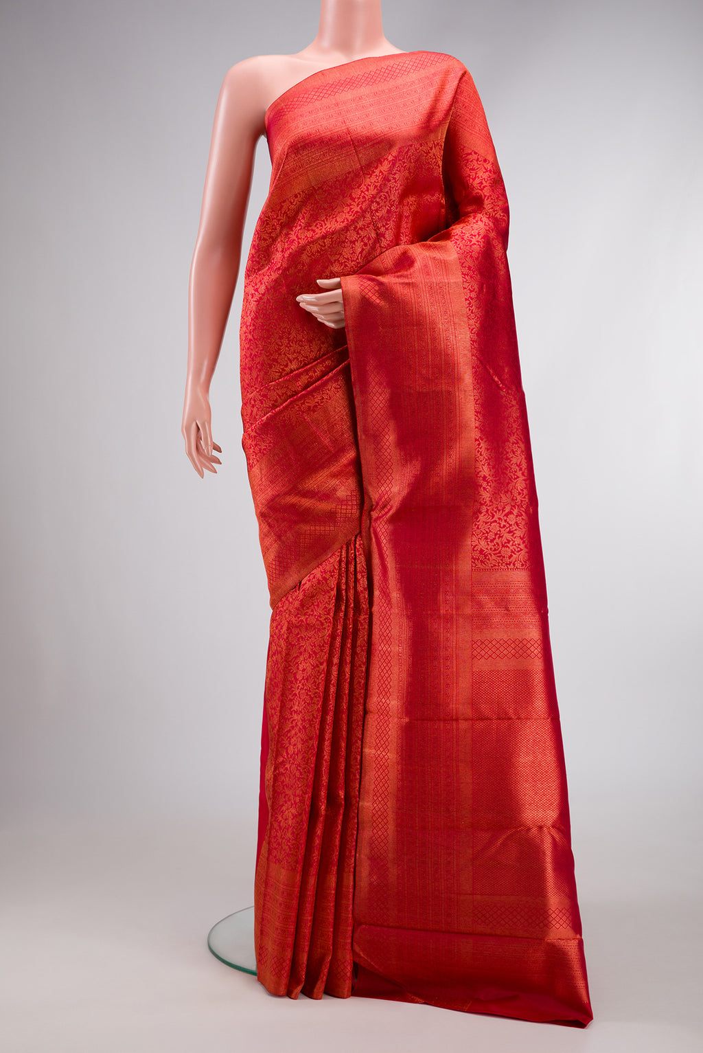 Red Dual Tone Kanjivaram Silk Saree with Zari Brocade on the body and Zari Border.  displayed on a mannequin