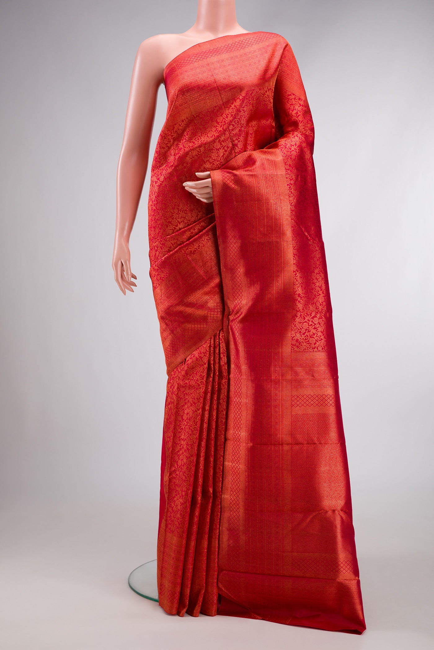 Red Dual Tone Kanjivaram Silk Saree with Zari Brocade on the body and Zari Border.  displayed on a mannequin