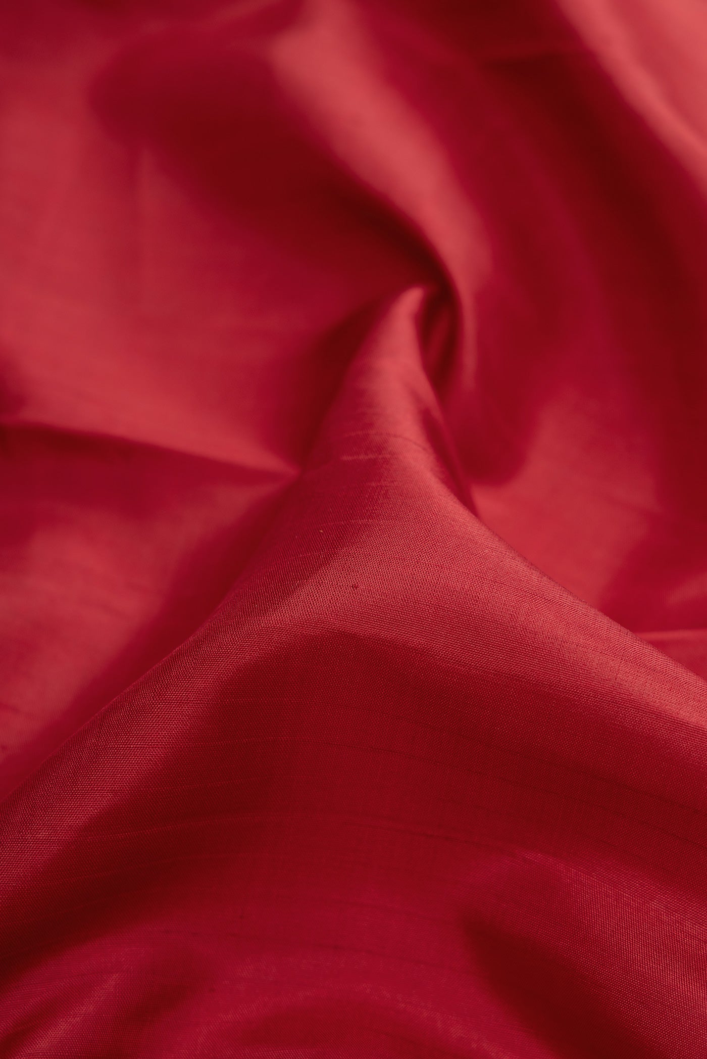 Close up of Maroon Dual Tone Kanjivaram Silk Saree with Plain Body and Zari Border.  displaying folds