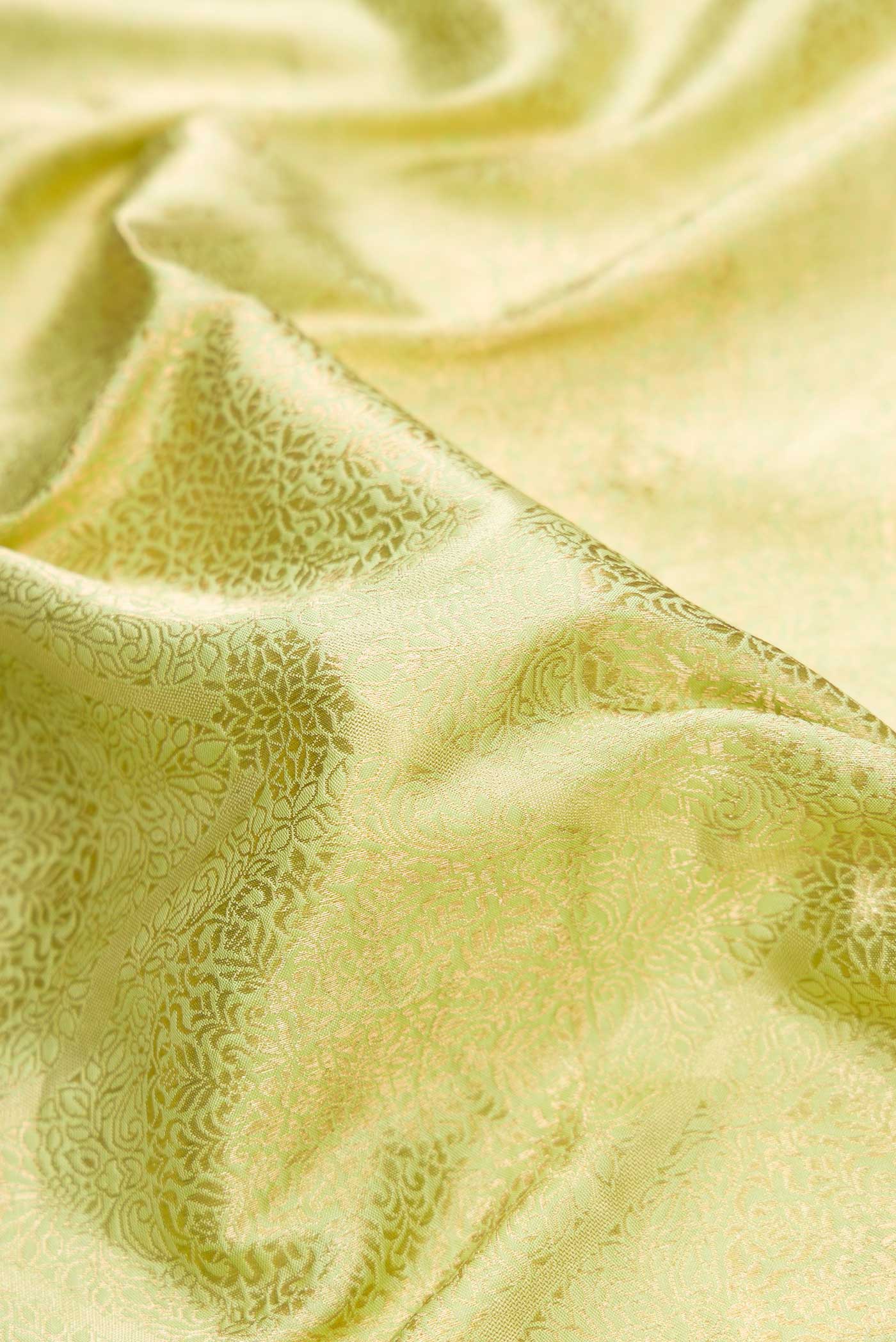 Close up of Pista Green Dual Tone Banarasi Silk Saree with Zari Brocade on the body and Zari Border.  displaying folds