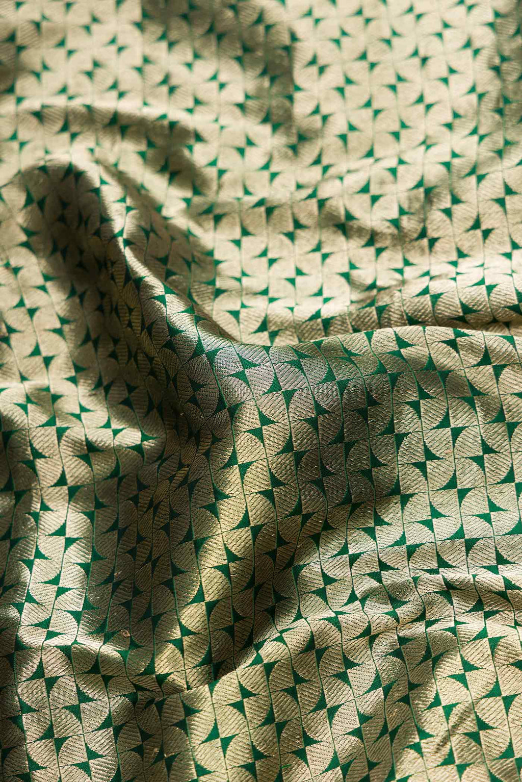 Close up of Bottle Green Dual Tone Banarasi Silk Saree with Zari Brocade on the body and Zari Border.  displaying folds