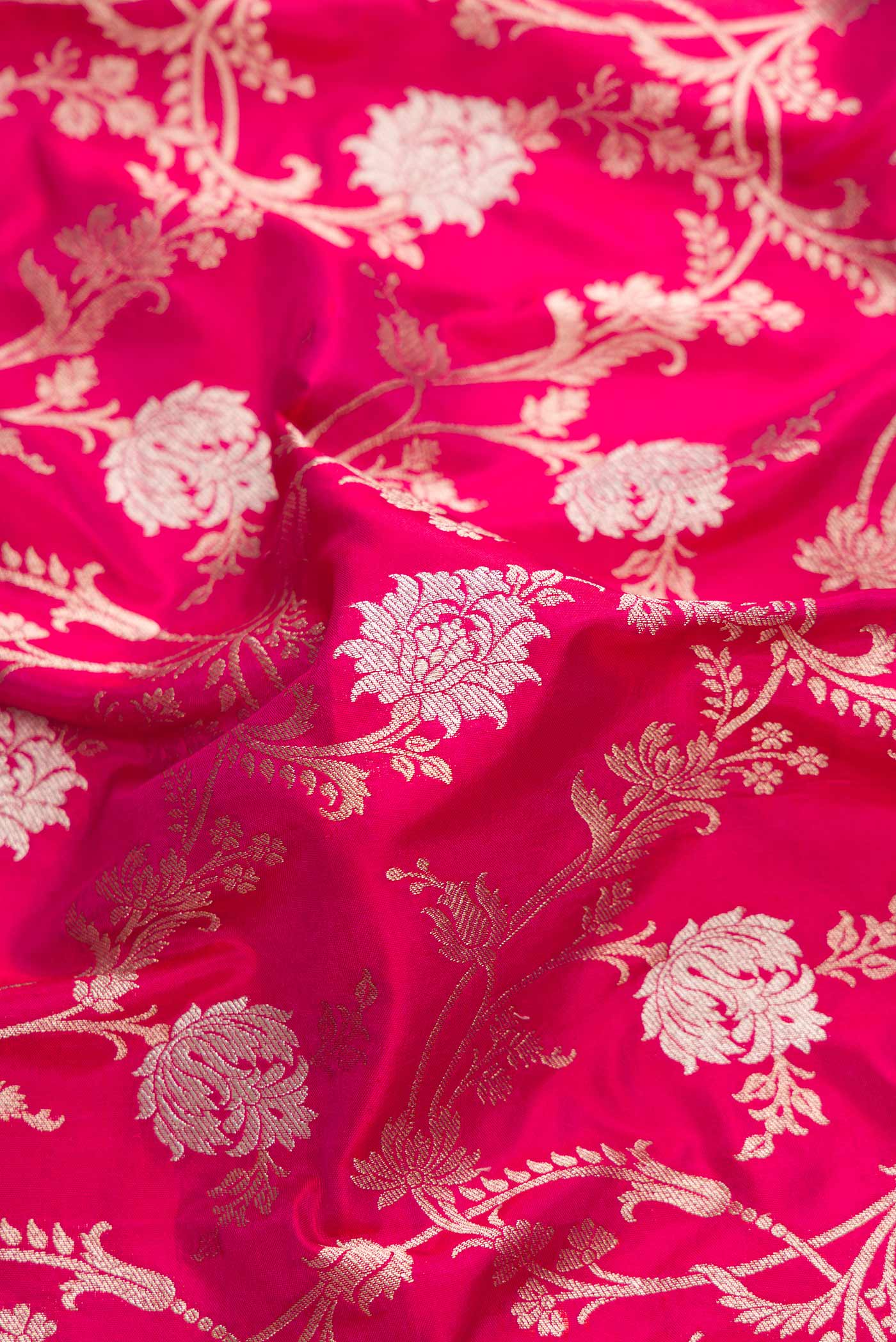 Close up of Pink Dual Tone Banarasi Silk Saree with Zari Brocade on the body and Zari Border.  displaying folds