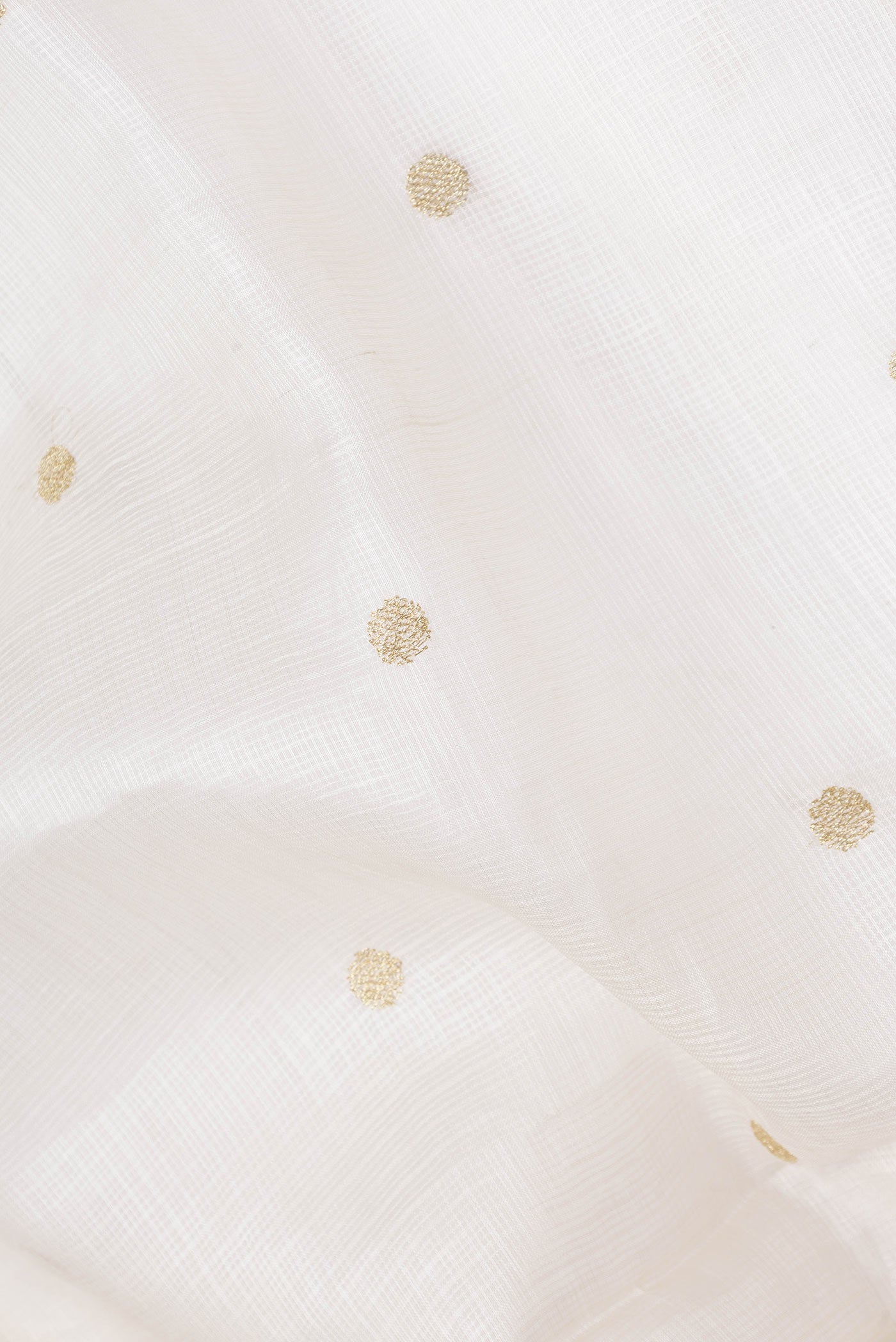 Close up of White Kota Silk Saree with Zari Butta on the body and Embroidery Border displaying folds