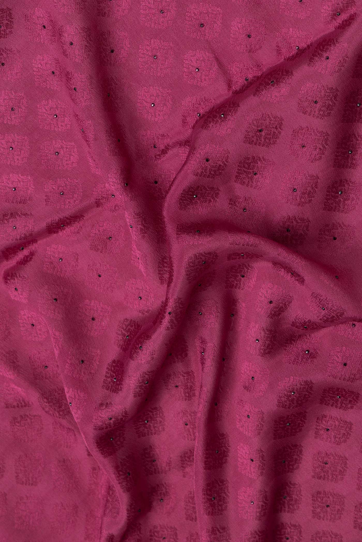 Close up of Magenta Dual Tone Georgette Saree with Jacquard design on the body and Zari Border.  displaying folds