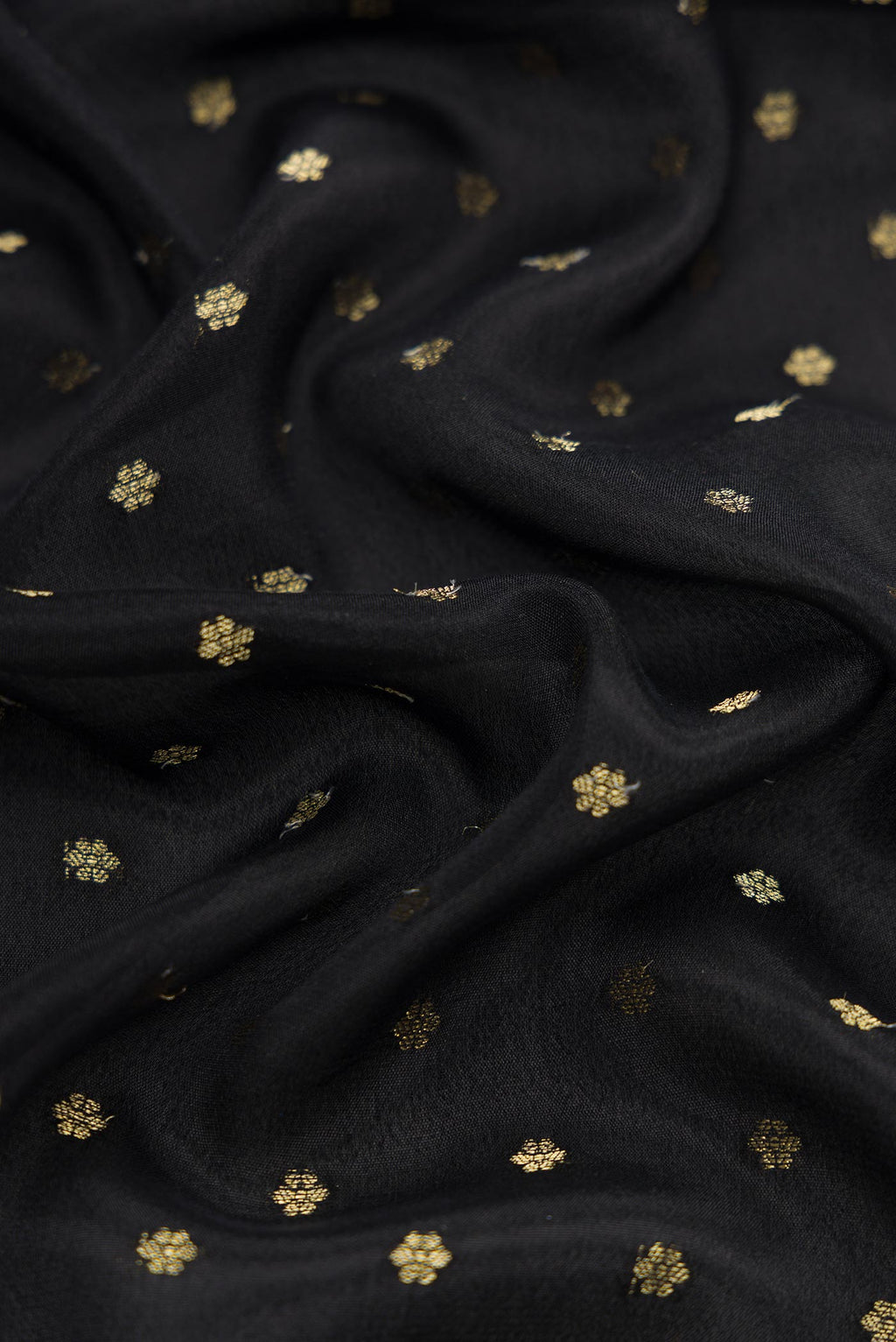Close up of Black Dual Tone Mysore Crepe Saree with Zari Butta on the body and Fancy Border.  displaying folds