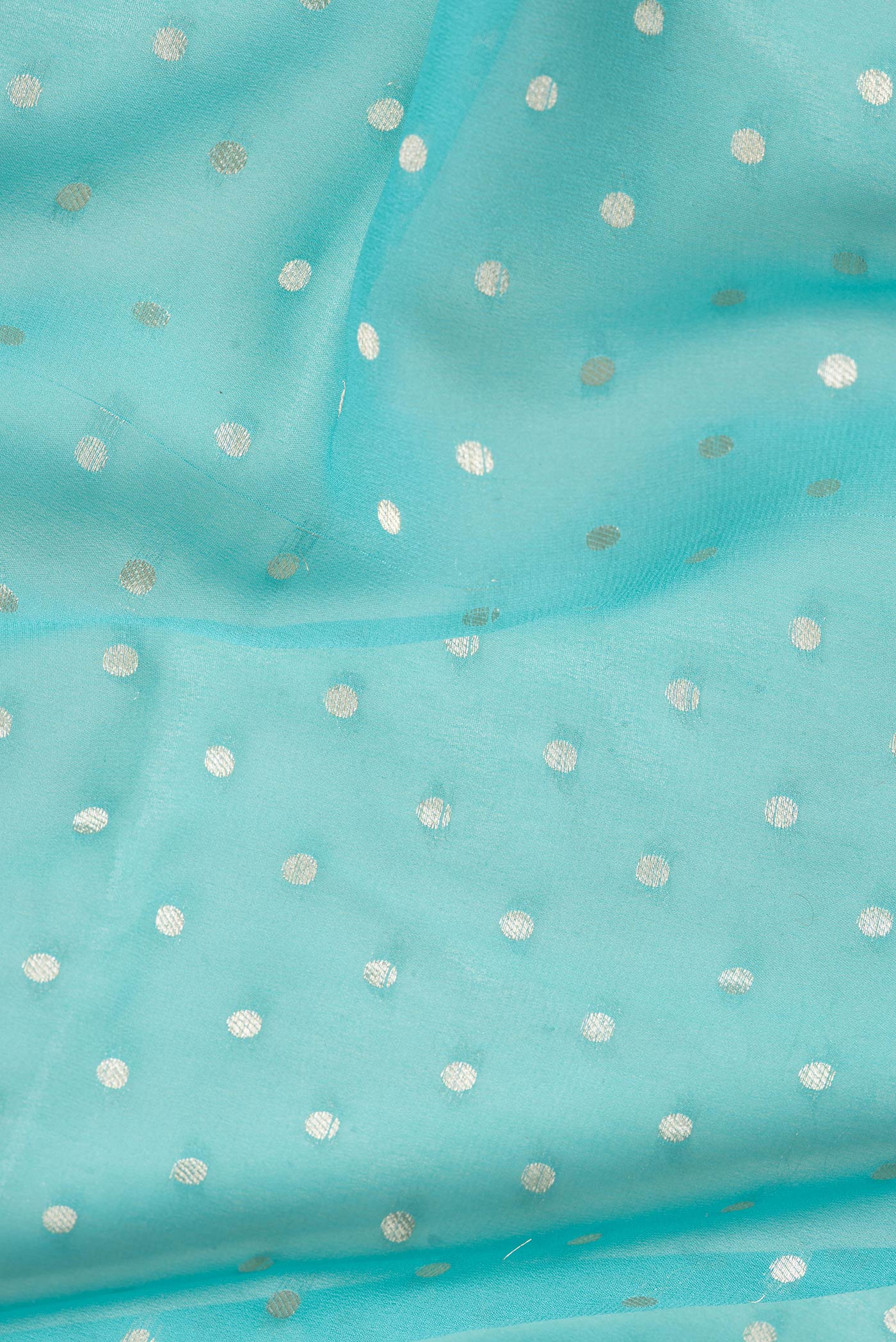 Close up of Sky Blue Dual Tone Banarasi Georgette Saree with Zari Brocade on the body and Zari Border.  displaying folds