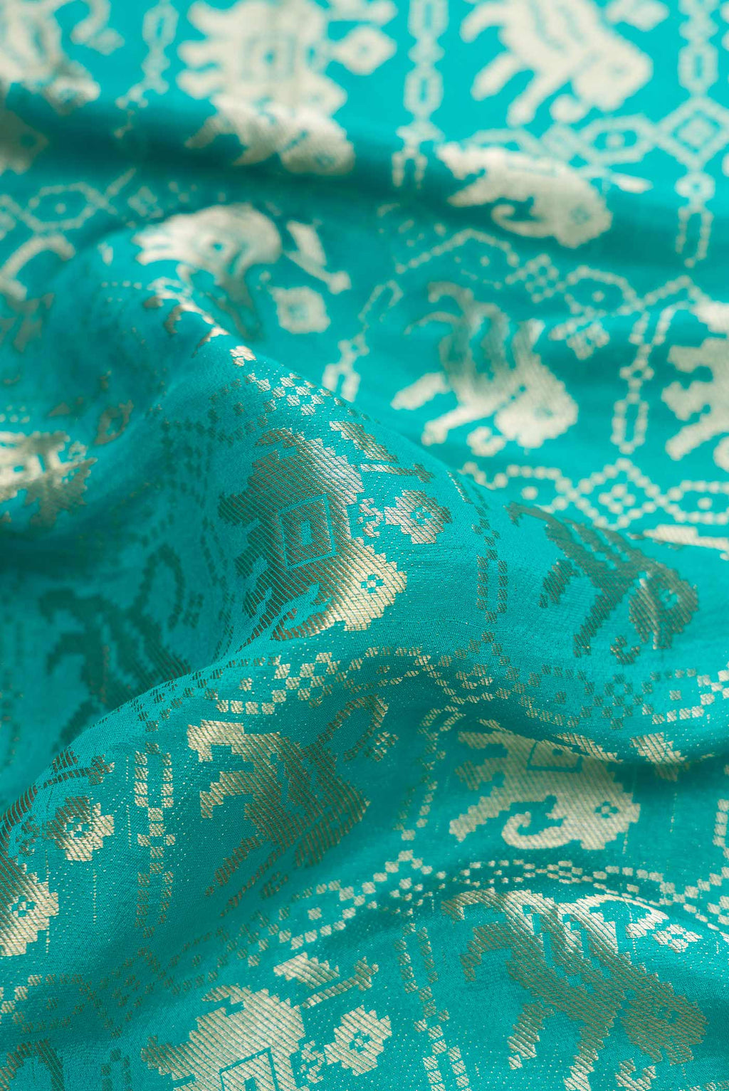 Close up of Sky Blue Dual Tone Banarasi Georgette Saree with Zari Brocade on the body and Zari Border.  displaying folds