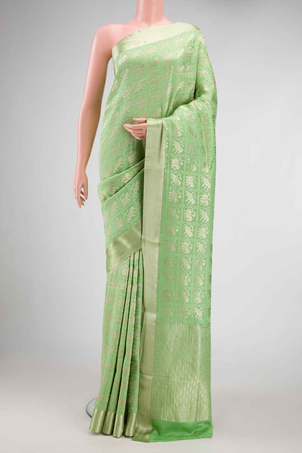 Pista Green Dual Tone Banarasi Georgette Saree with Zari Brocade on the body and Zari Border.  displayed on a mannequin