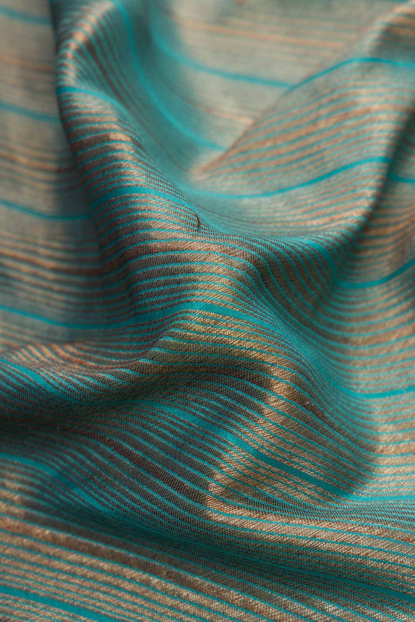 Close up of Sky Blue Dual Tone Banarasi Georgette Saree with Zari Brocade on the body and Zari Border.  displaying folds