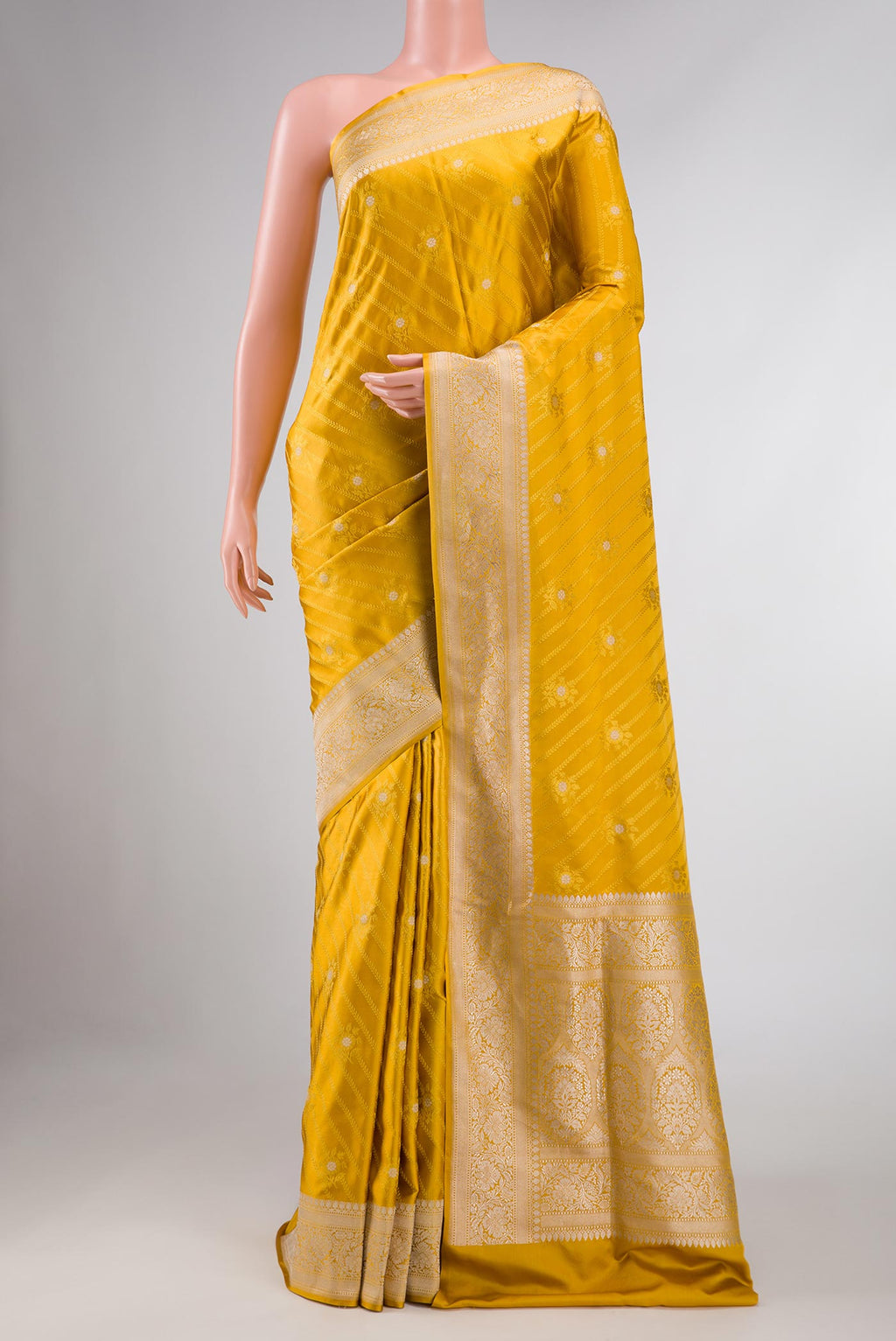 Pure Silk Pure Zari Mustard Dual Tone Banarasi Saree with Jacquard With Zari Butta on the body and Zari Border displayed on a mannequin