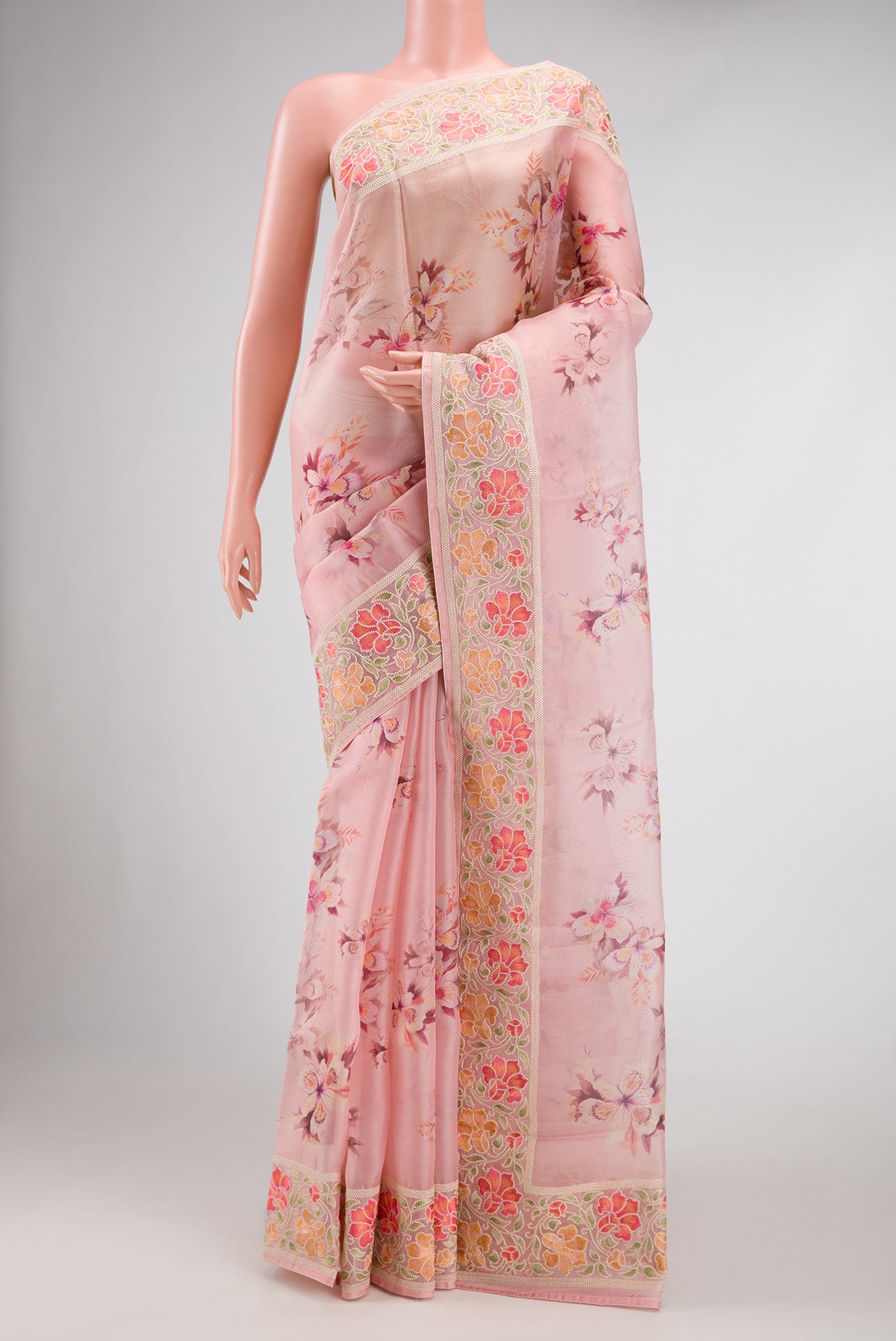 Golden Peach Dual Tone Organza Silk Saree with Printed design on the body and Zari Border.  displayed on a mannequin