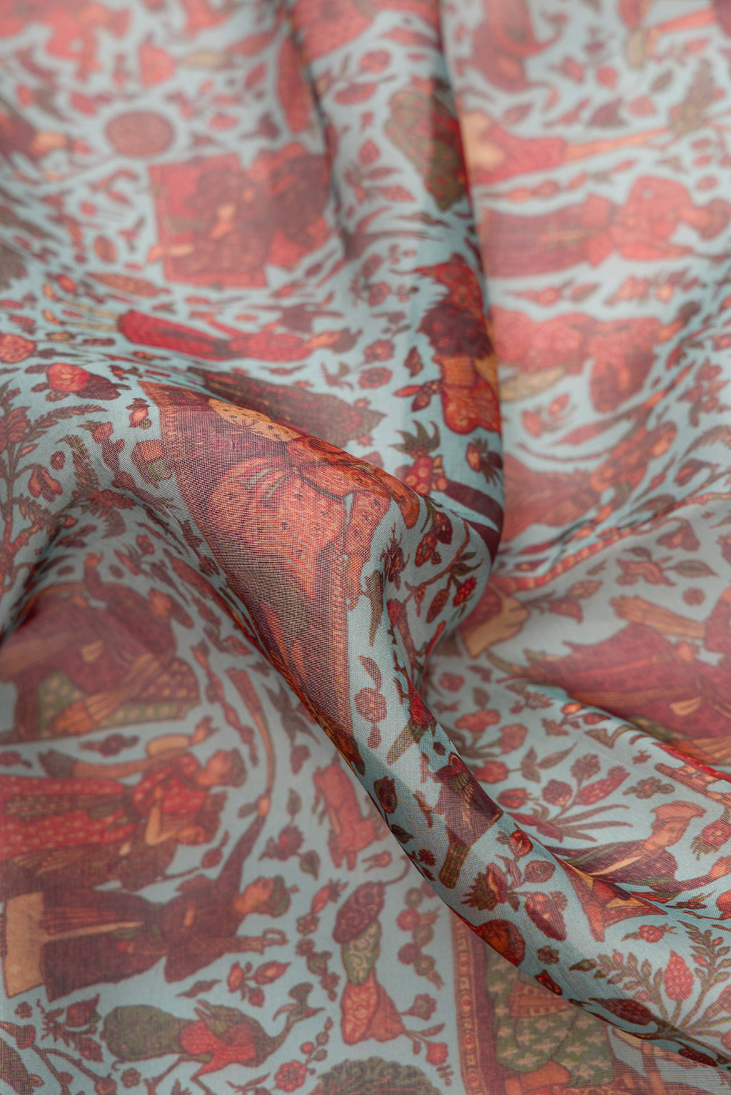 Close up of Light Green Dual Tone Organza Silk Saree with Printed design on the body and Zari Border.  displaying folds
