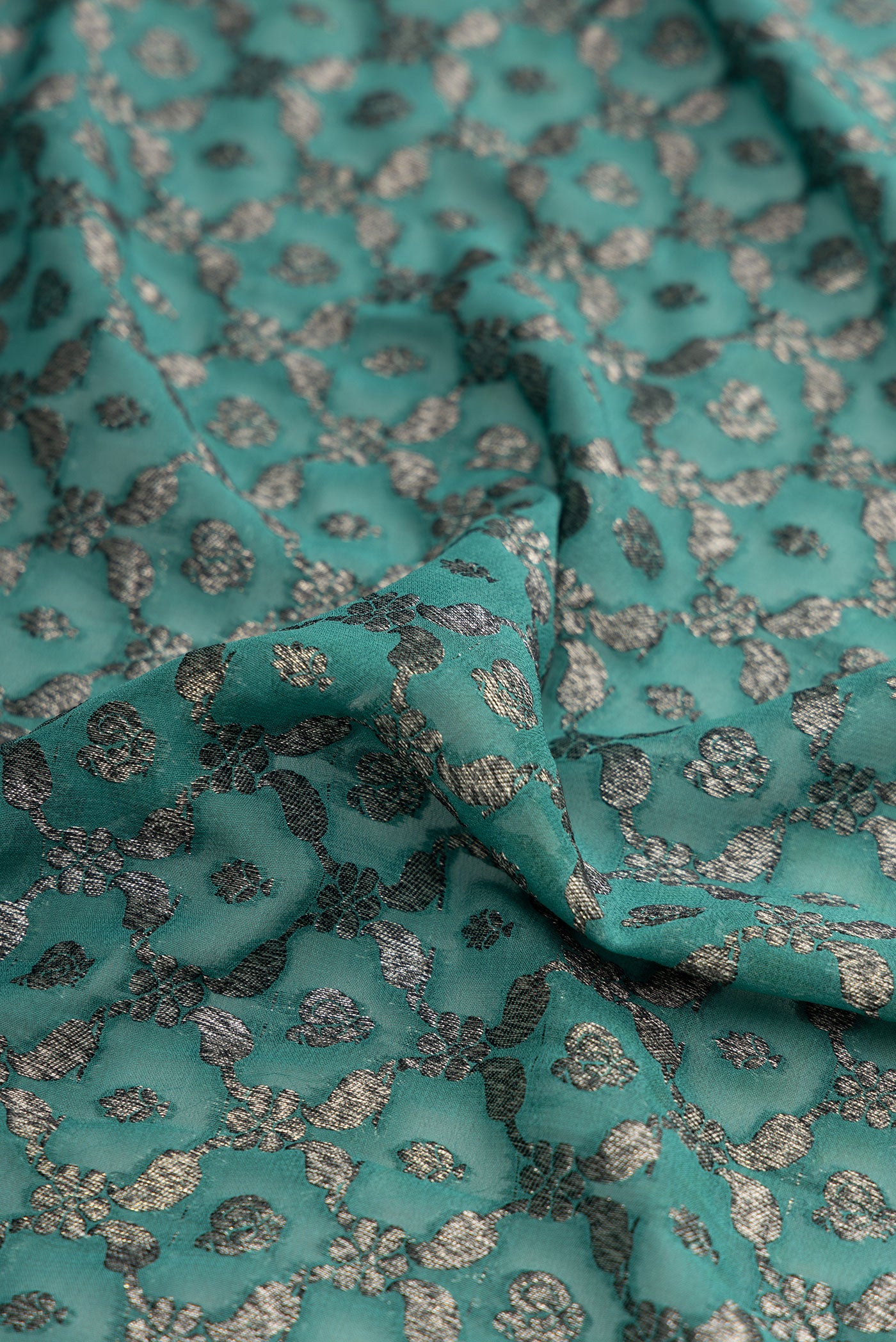 Close up of Green Dual Tone Mysore Georgette Saree with Zari Brocade on the body and Zari Border.  displaying folds