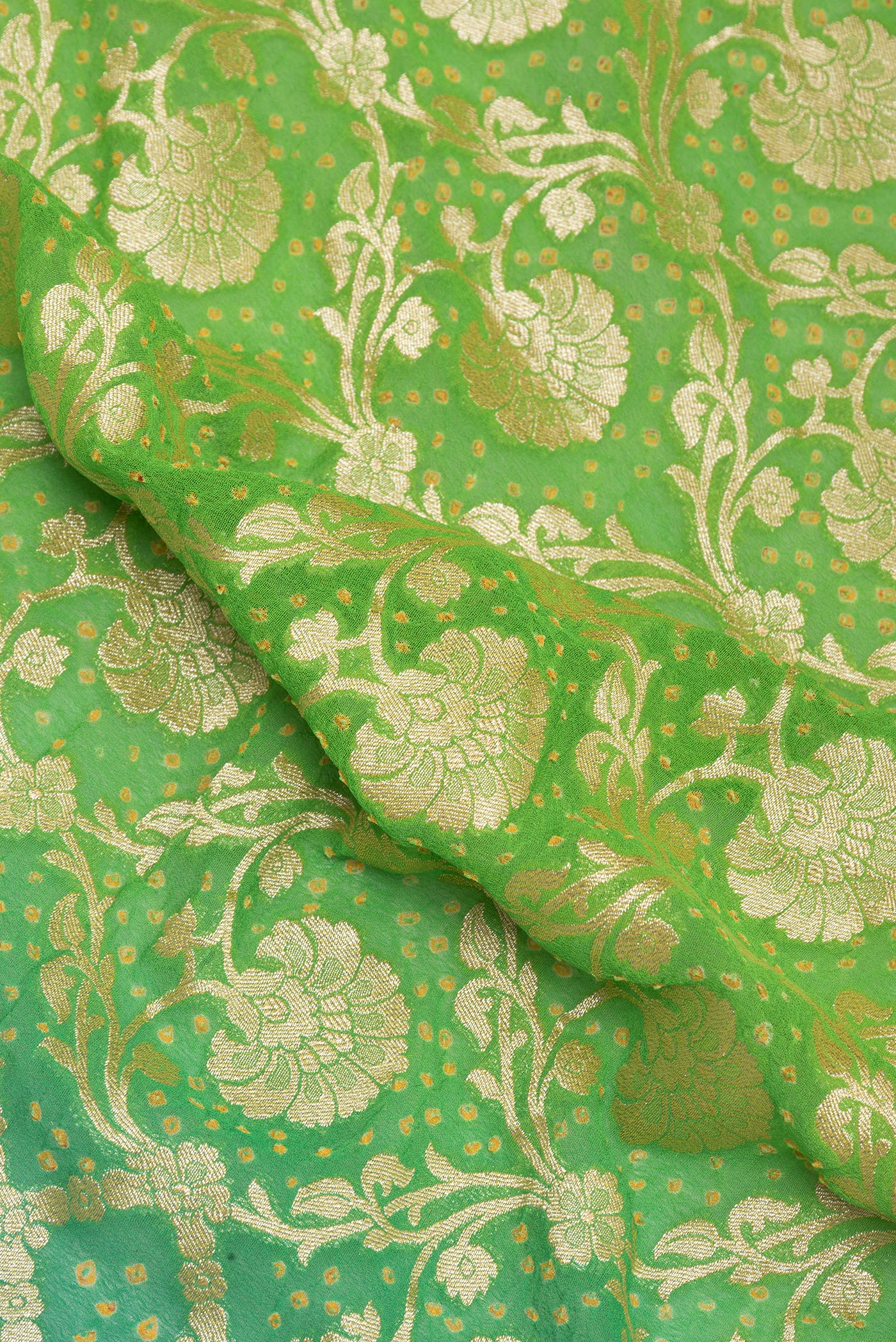 Close up of Parrot Green Banarasi Georgette Saree with Zari Brocade on the body and Zari Border.  displaying folds