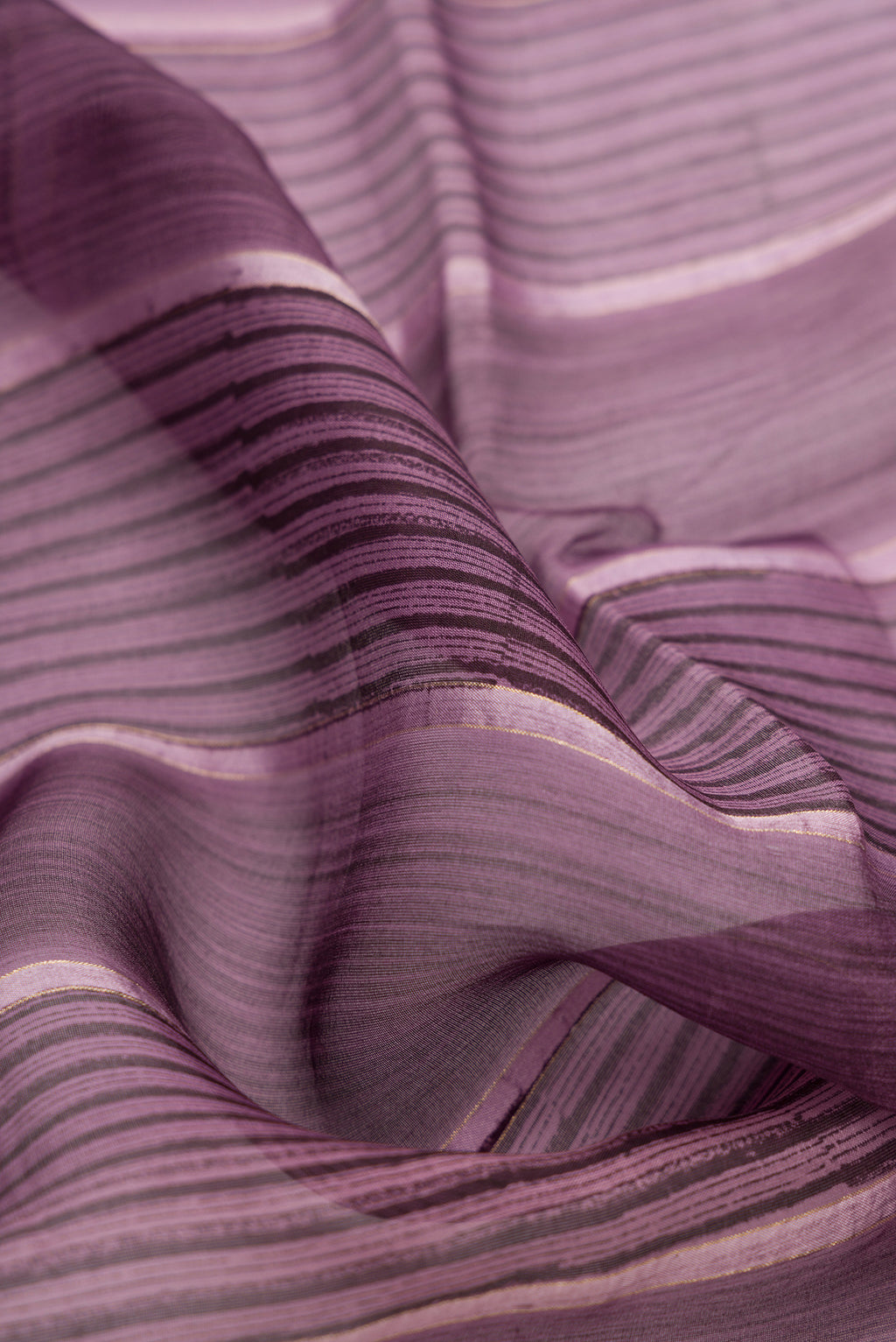Close up of Burgundy Dual Tone Organza Silk Saree with Printed design on the body and Zari Border.  displaying folds