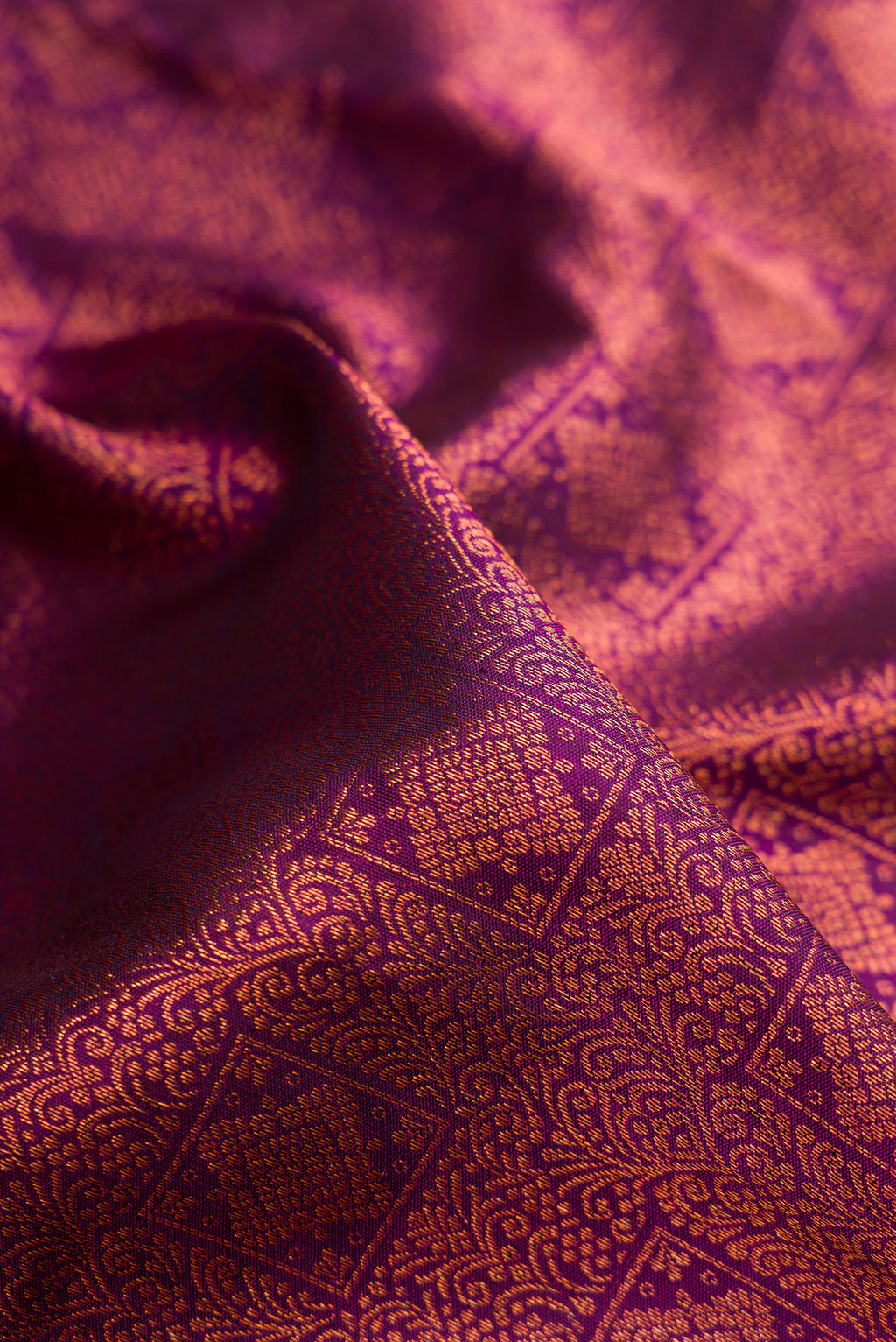 Close up of Purple Dual Tone Kanchipuram Silk Saree with Zari Brocade on the body and Fancy Border.  displaying folds