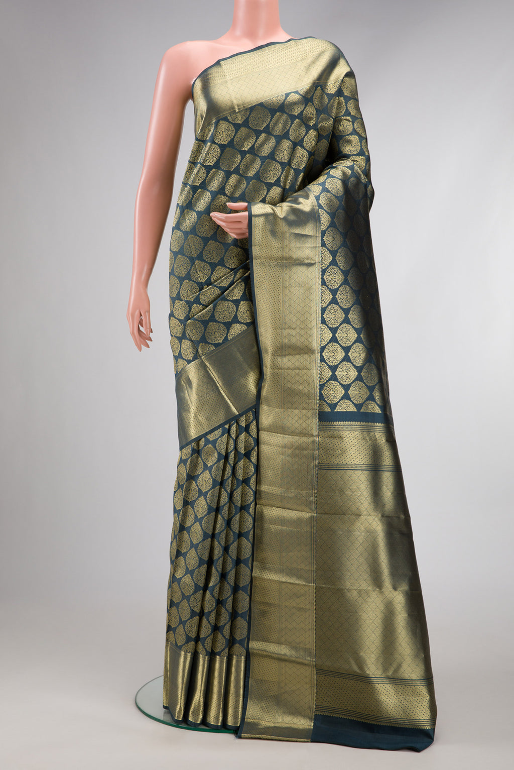 Grey Dual Tone Kanchipuram Silk Saree with Zari Brocade on the body and Zari Border.  displayed on a mannequin