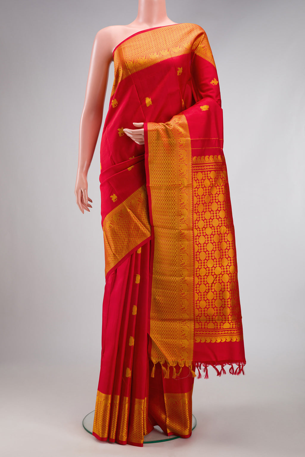 Red Kanjivaram Silk Saree with Thread Butta on the body and Thread Border.  displayed on a mannequin