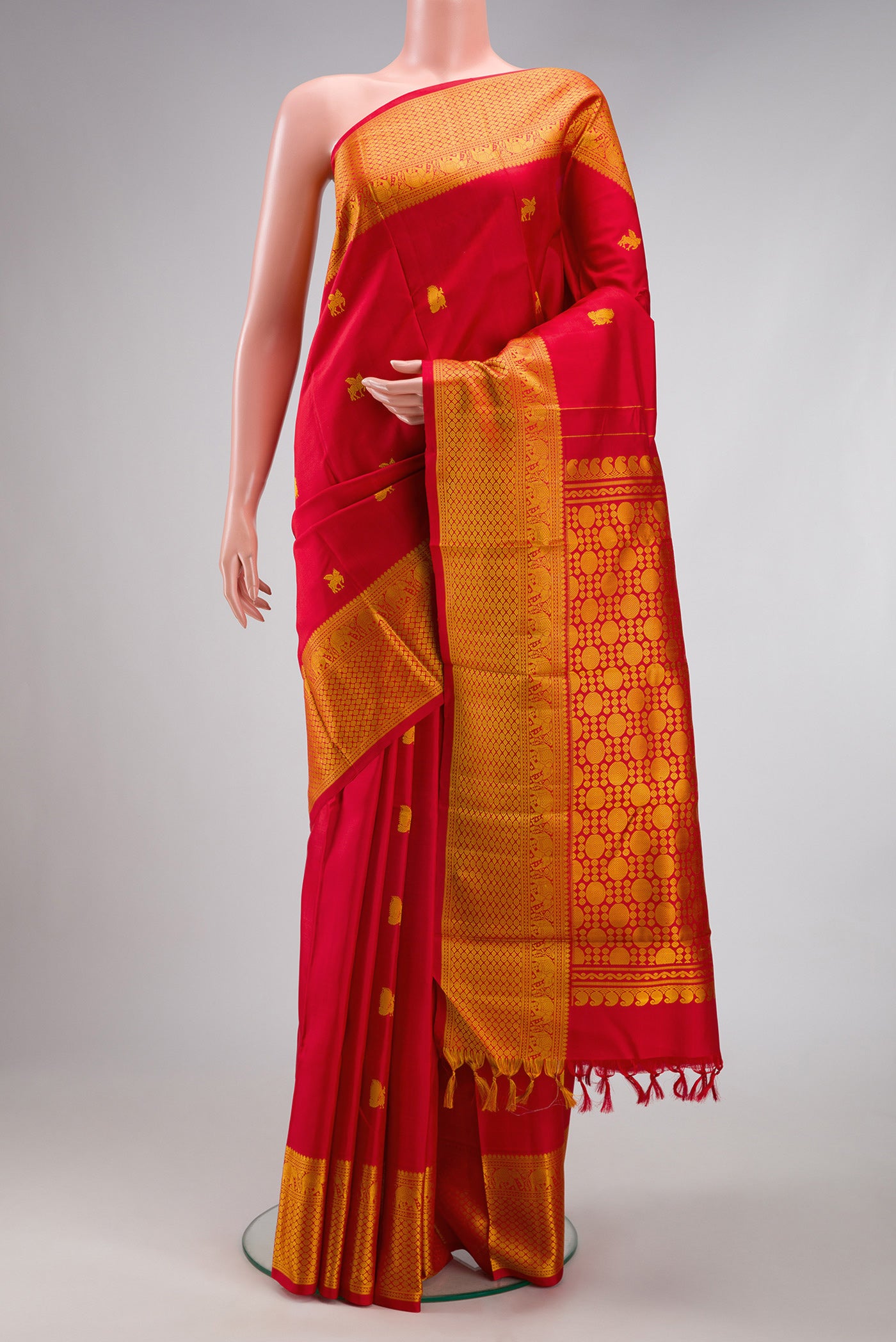 Red Kanjivaram Silk Saree with Thread Butta on the body and Thread Border.  displayed on a mannequin