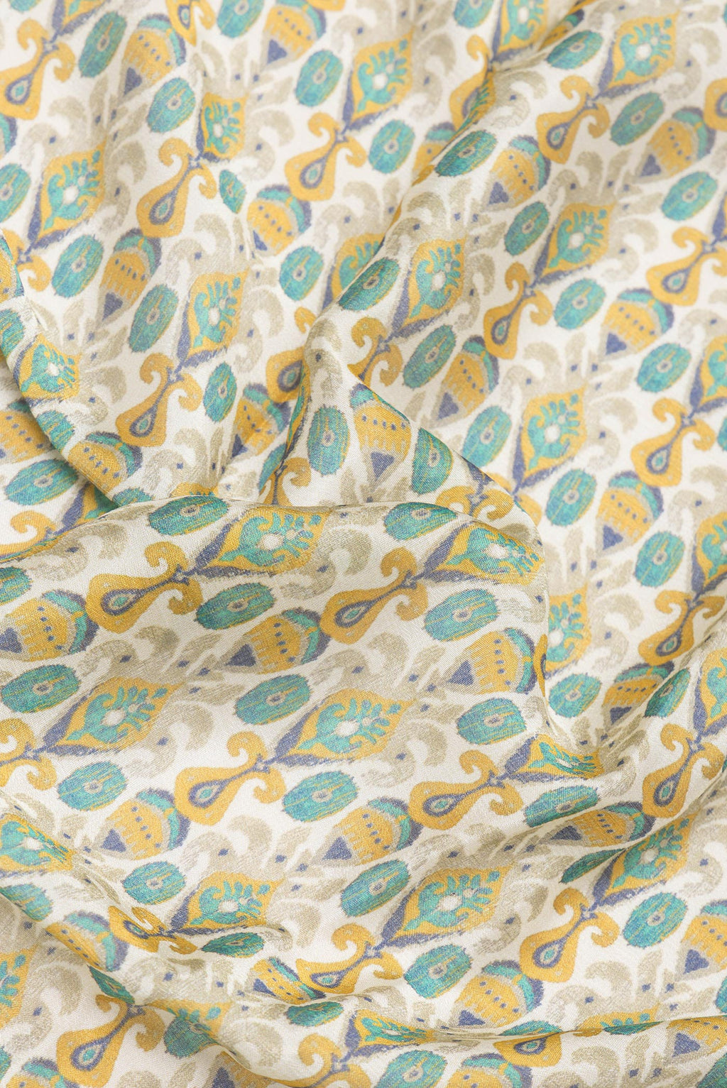 Close up of Beige Blended Crepe Saree with Printed design on the body and Printed Border.  displaying folds