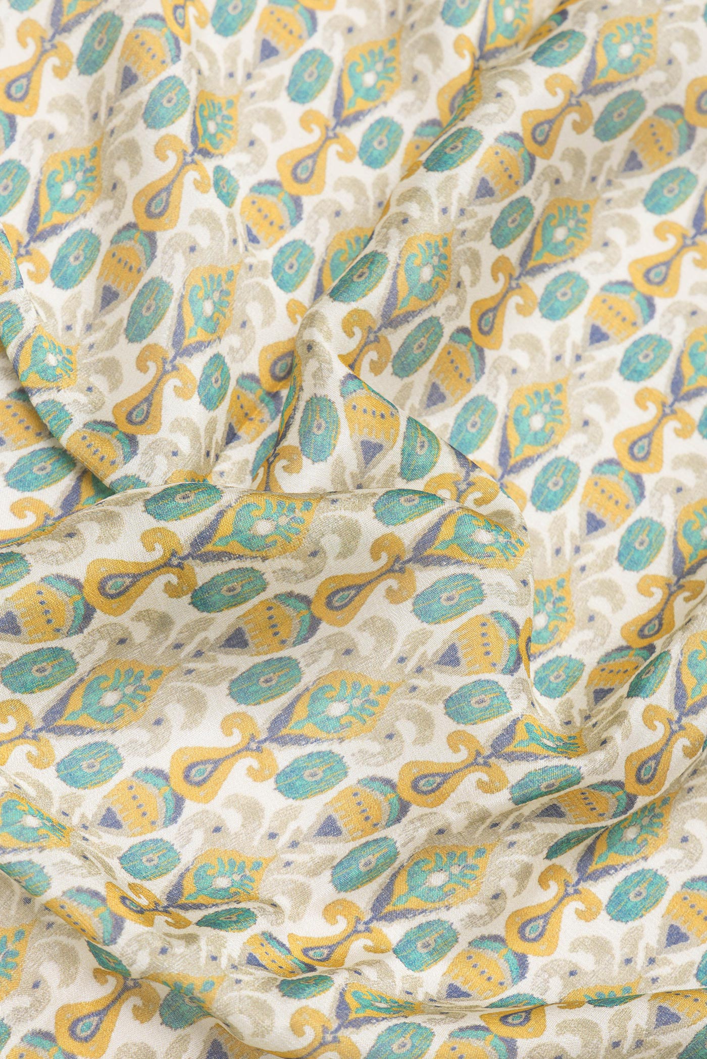 Close up of Beige Blended Crepe Saree with Printed design on the body and Printed Border.  displaying folds