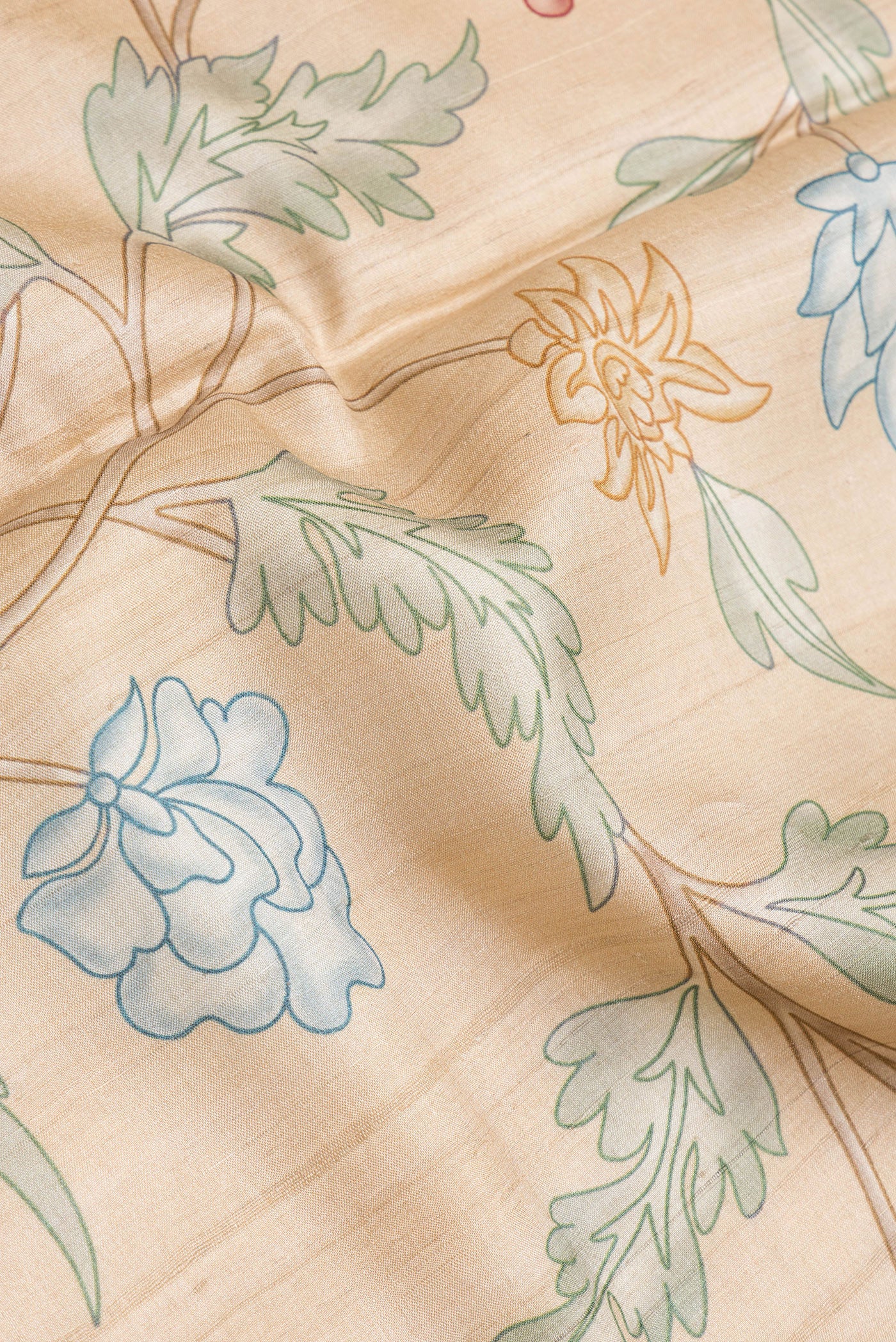 Close up of Beige Dual Tone Tussar Silk Saree with Printed design on the body and Embroidery Border.  displaying folds