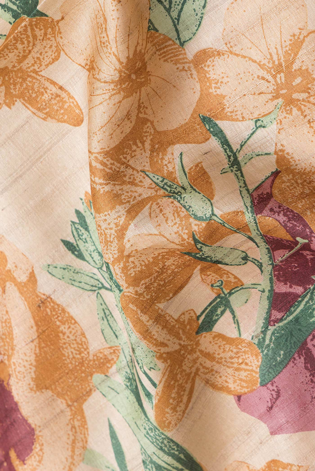 Close up of Beige Dual Tone Tussar Silk Saree with Printed design on the body and Embroidery Border.  displaying folds